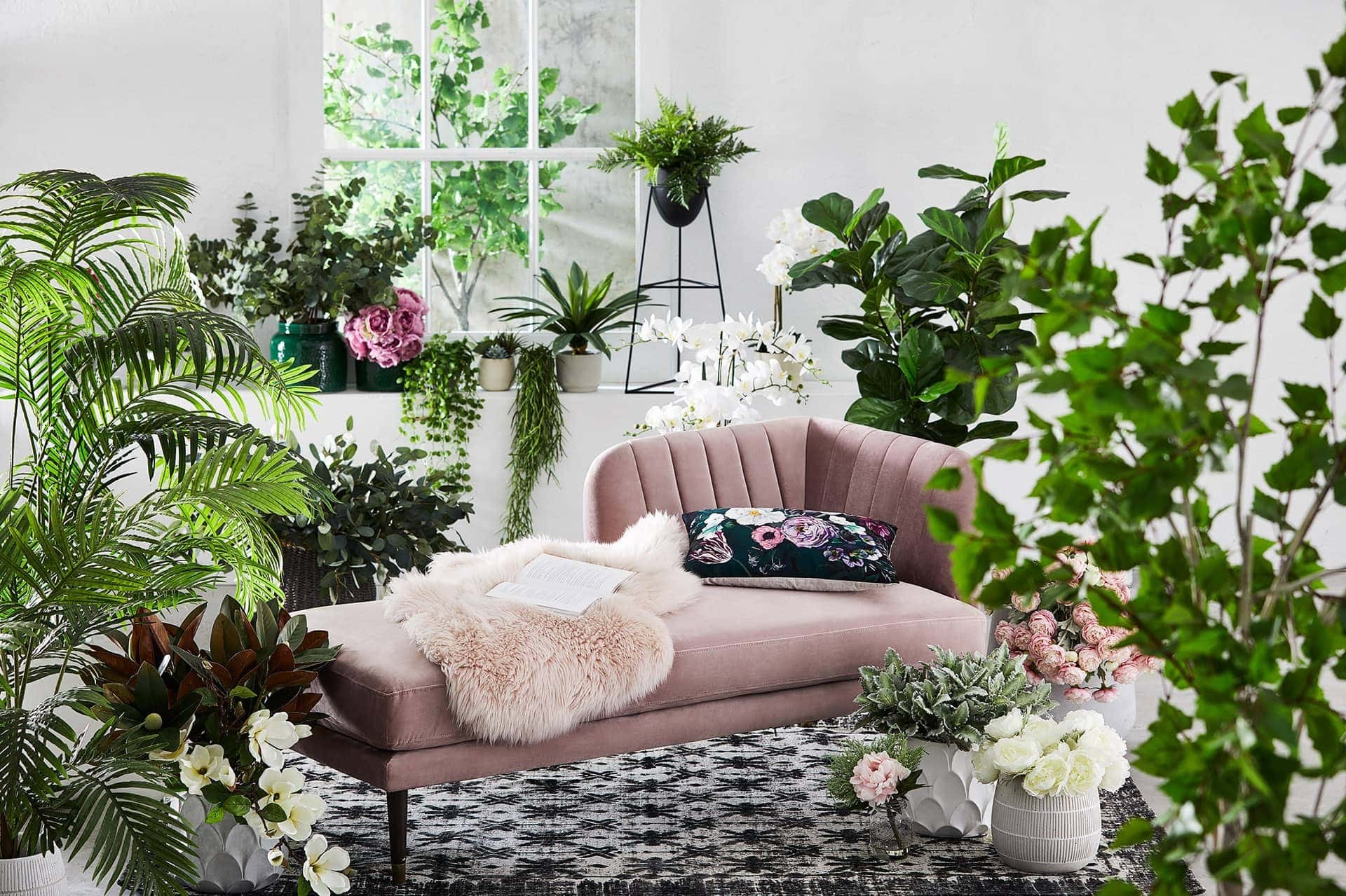 adairs fake plants and flowers around pink velvet daybed