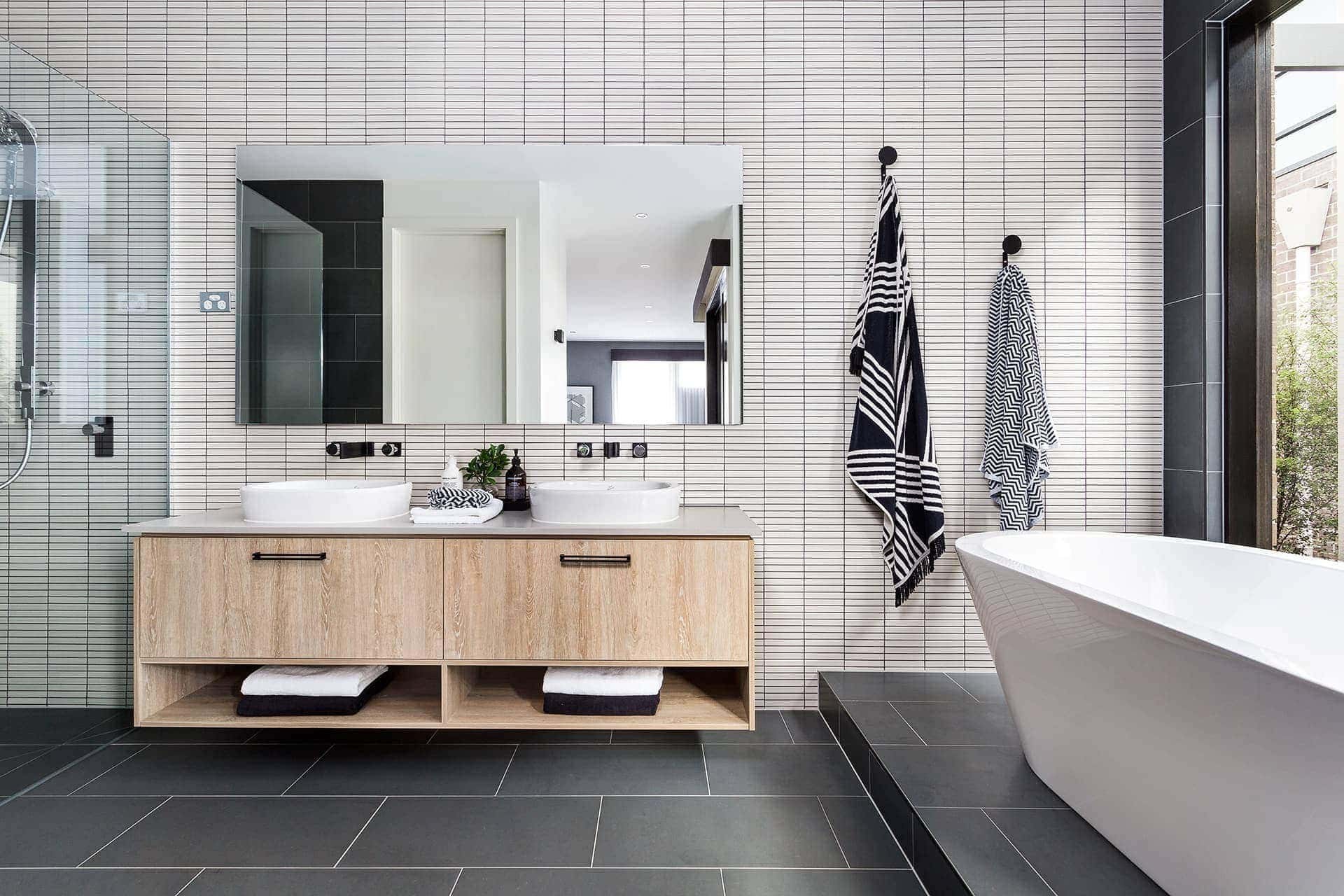 bathroom with white rectangular bathroom tiles grey grout and charcoal floor tiles