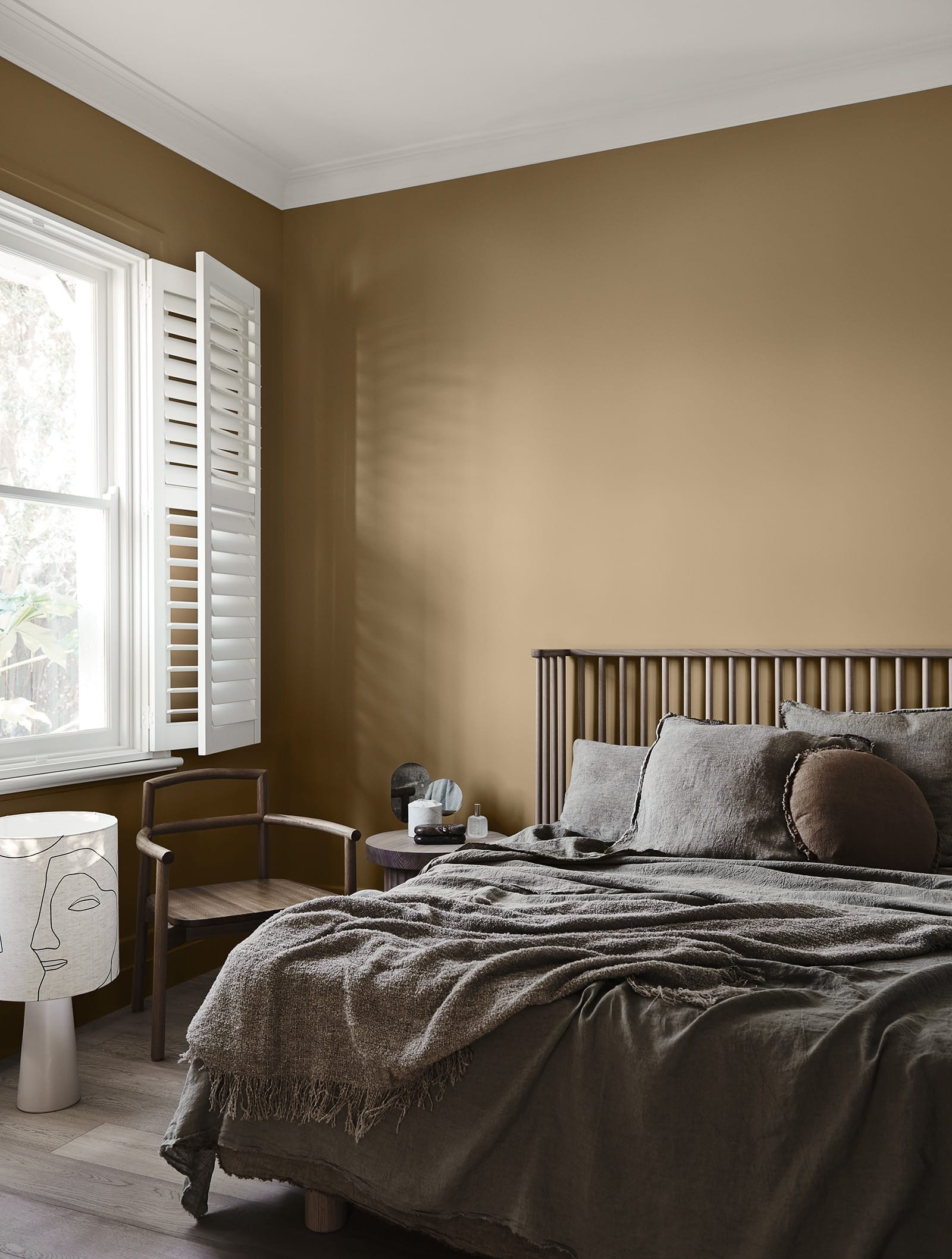 bedroom with caramel walls and dark brown bedspread neutral interior design scheme