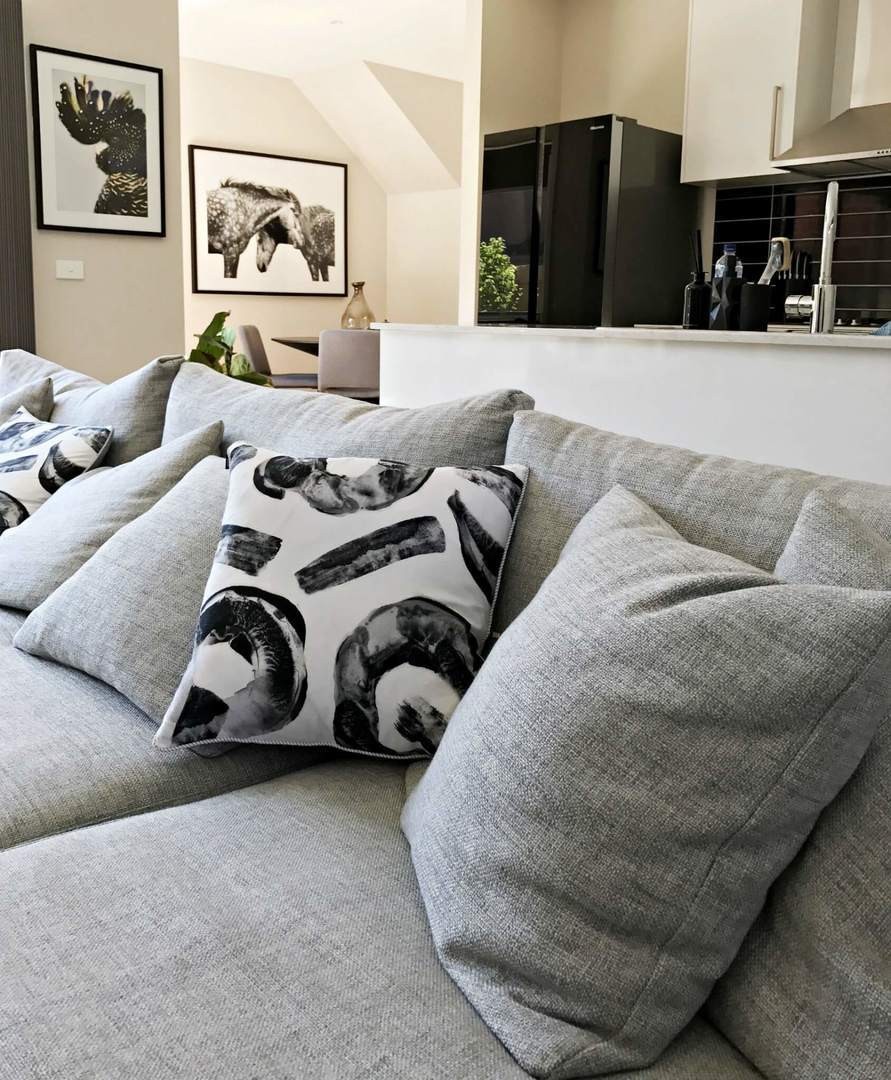 black and white cushion on grey sofa with urban road art the life creative