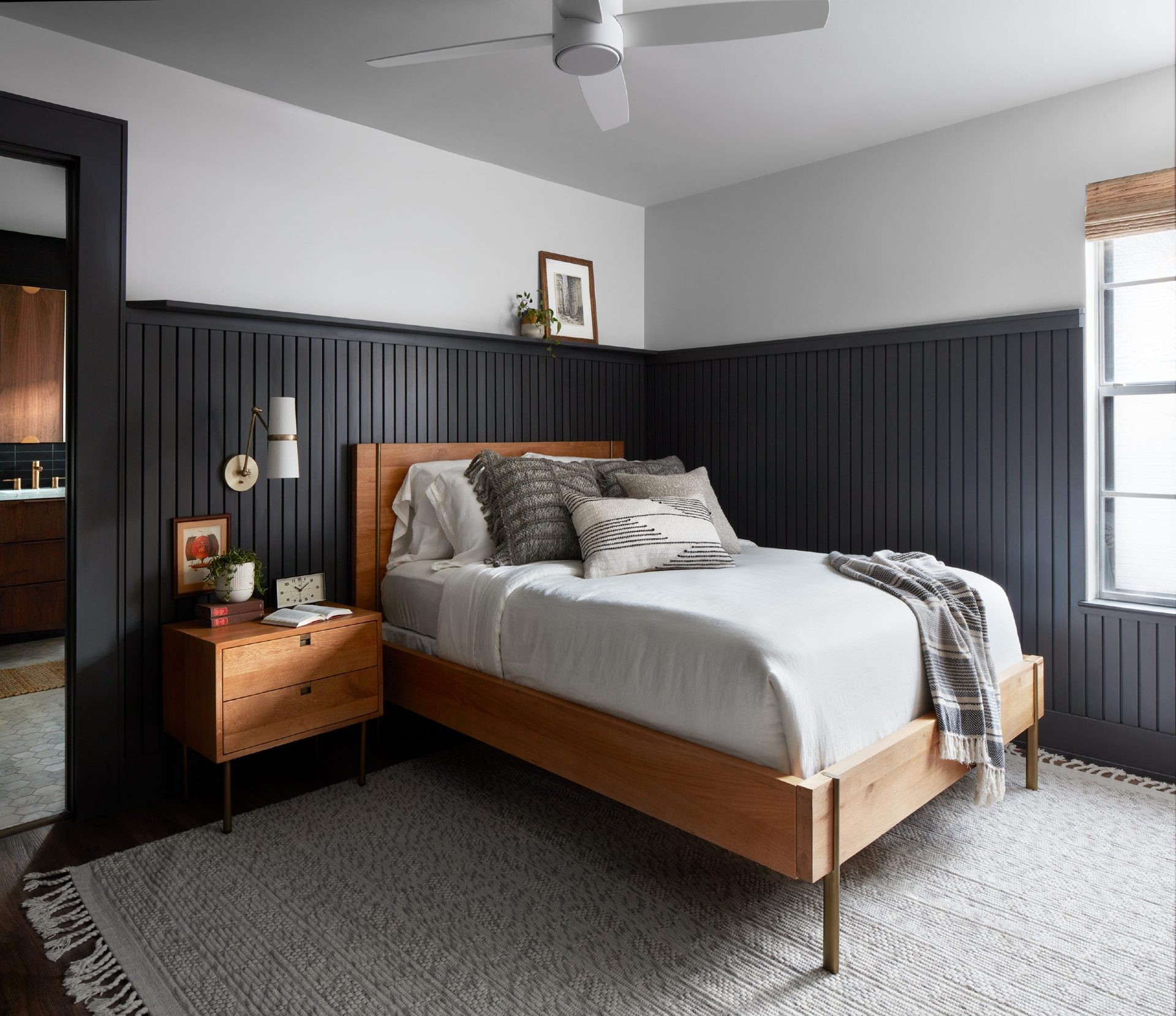 black timber panel bedroom wall with mid century bed and bedside table