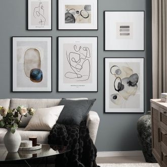 black white and grey gallery wall artworks in living room desenio prints framed on wall