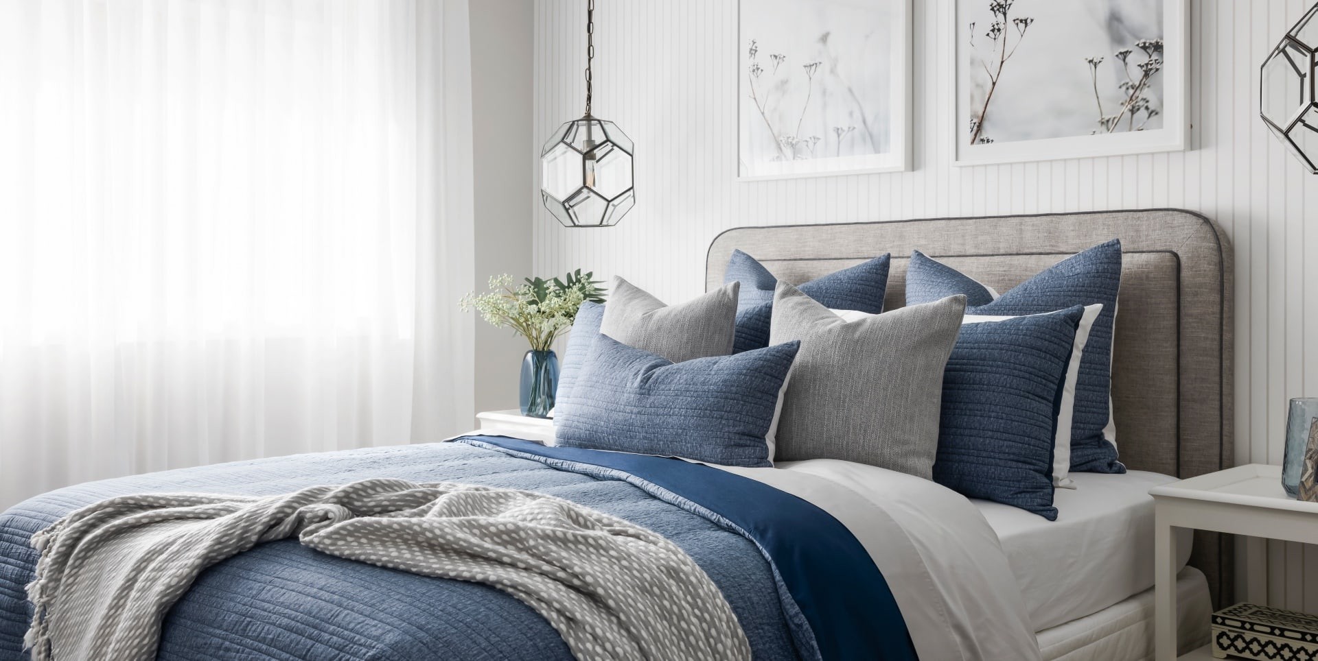 blue and white hamptons bedroom design with grey headboard and industrial pendant lightsblue and white hamptons bedroom design with grey headboard and industrial pendant lights
