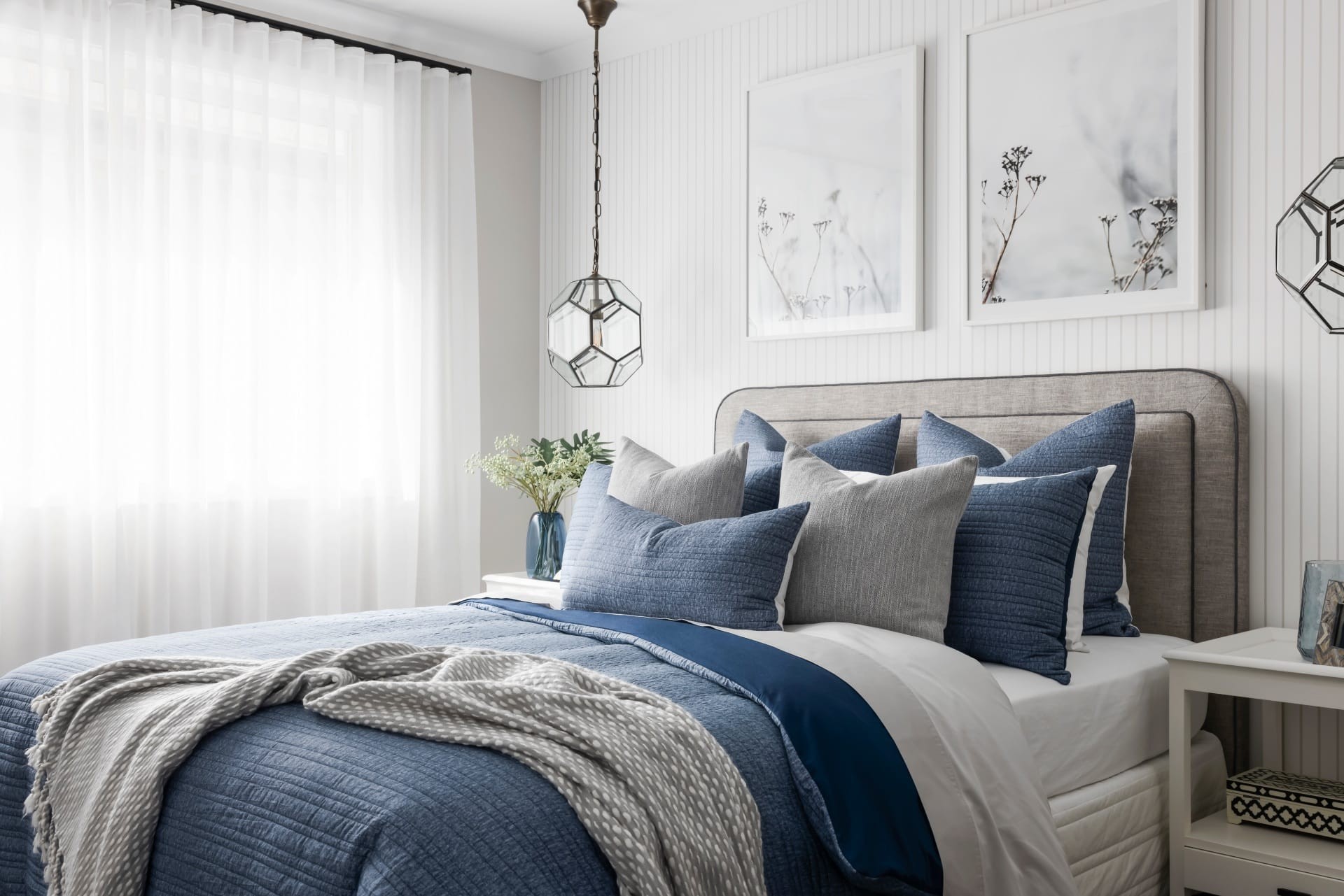 blue and white hamptons bedroom styling with glass hamptons pendant lights and stripe wallpaper