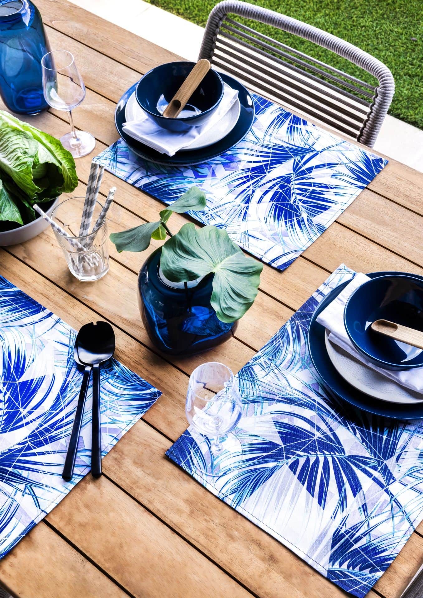 blue and white tropical print outdoor dining placemats on timber table