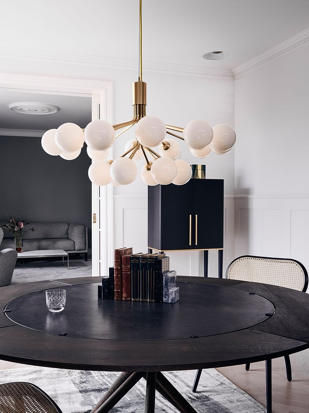 brass multi bulb pendant light over round dining table from finnish design shop