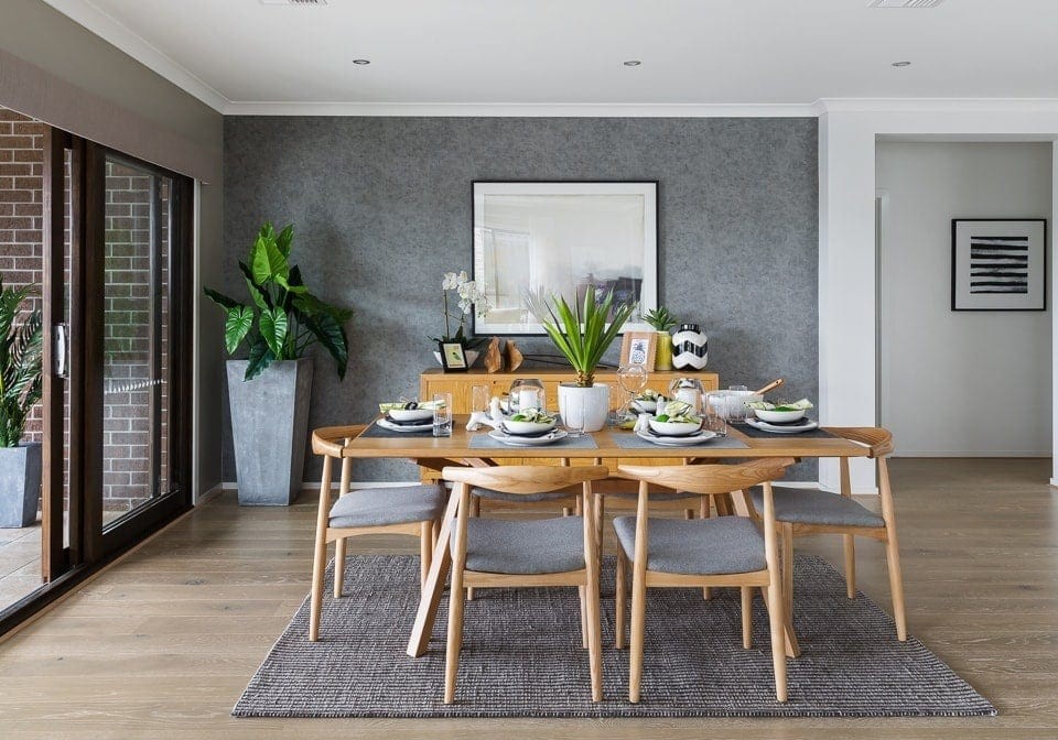 coastal dining room with blonde timber dining setting and grey feature wall