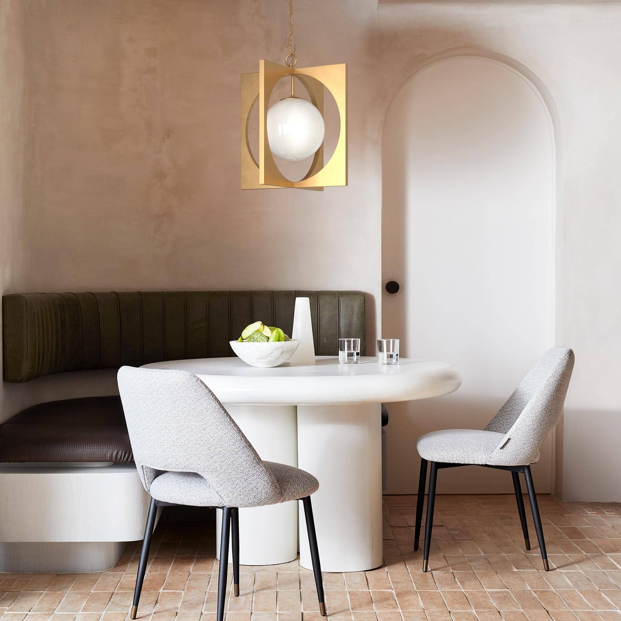 coco republic dining room with rond white dining table and gold pendant above