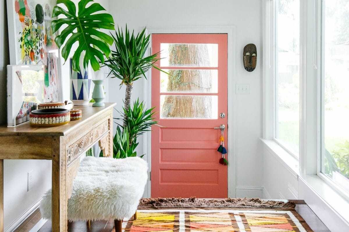 colourful entryway with coloured aztec rug pink door and moroccan side table