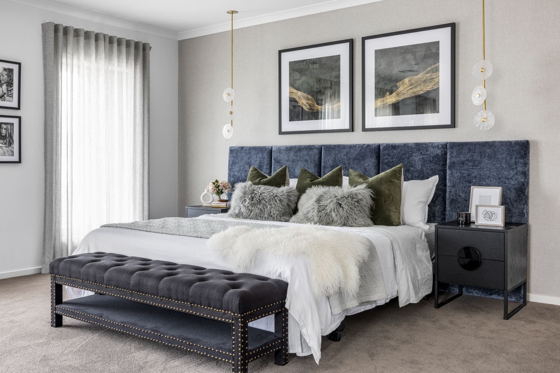 contemporary luxe bedroom with blue velvet headboard grey sheer curtains and charcoal bench seat