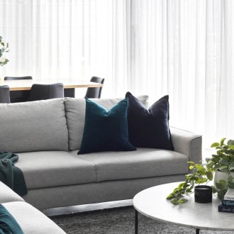 contemporary luxe living room with grey king living sofa and round marble coffee table
