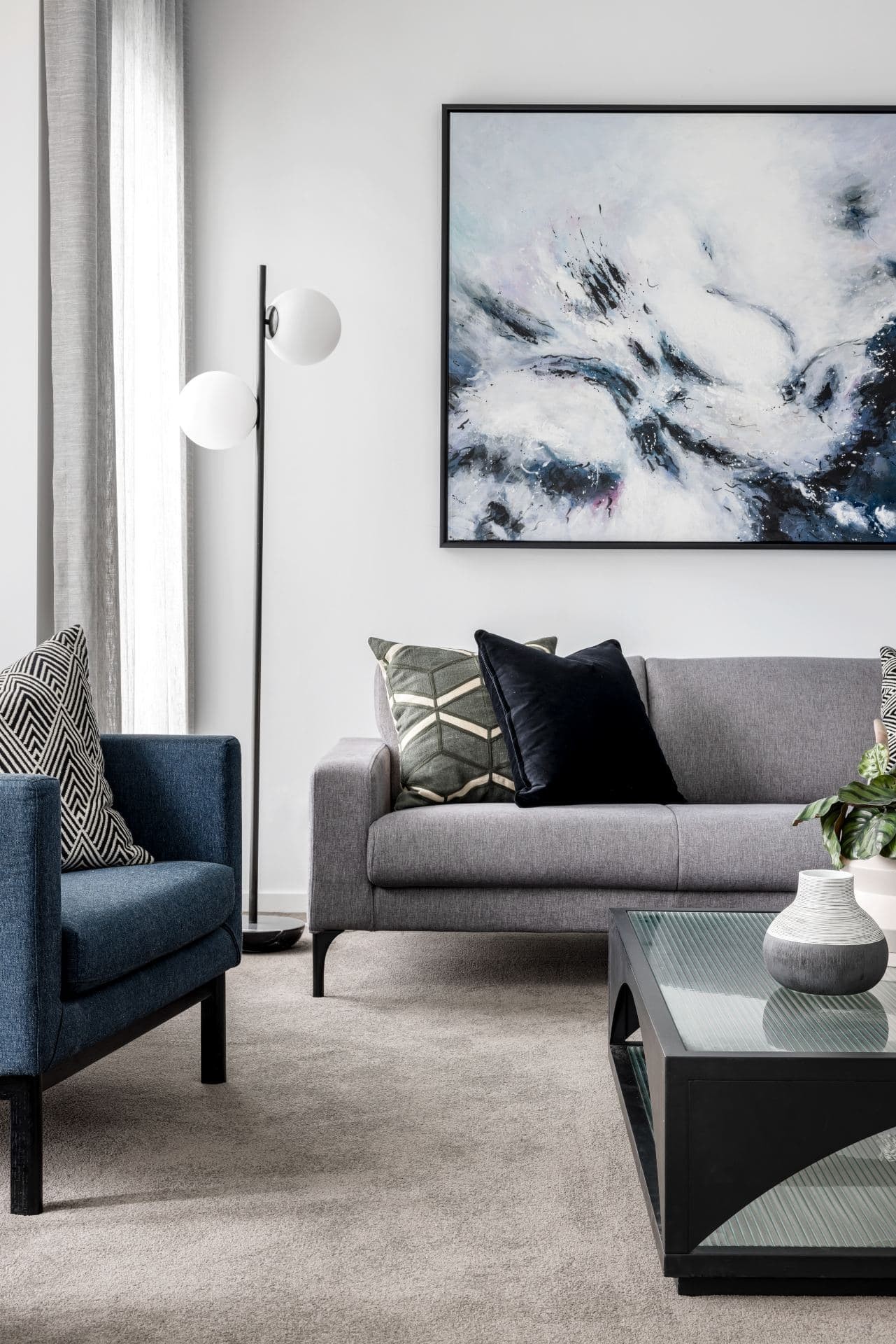 contemporary luxe living room with grey king living sofa coco republic coffee table and navy blue armchairs