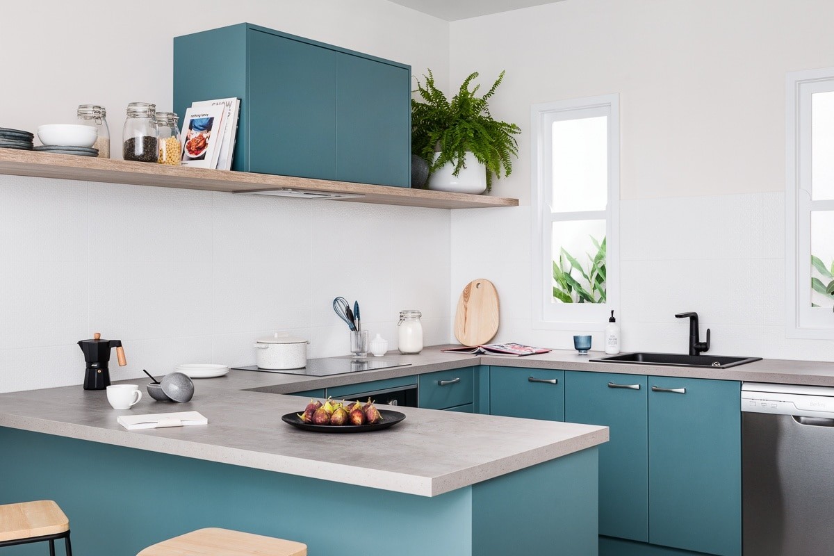 dark teal coloured kitchen cabinets with grey concrete countertop kaboodle kitchens