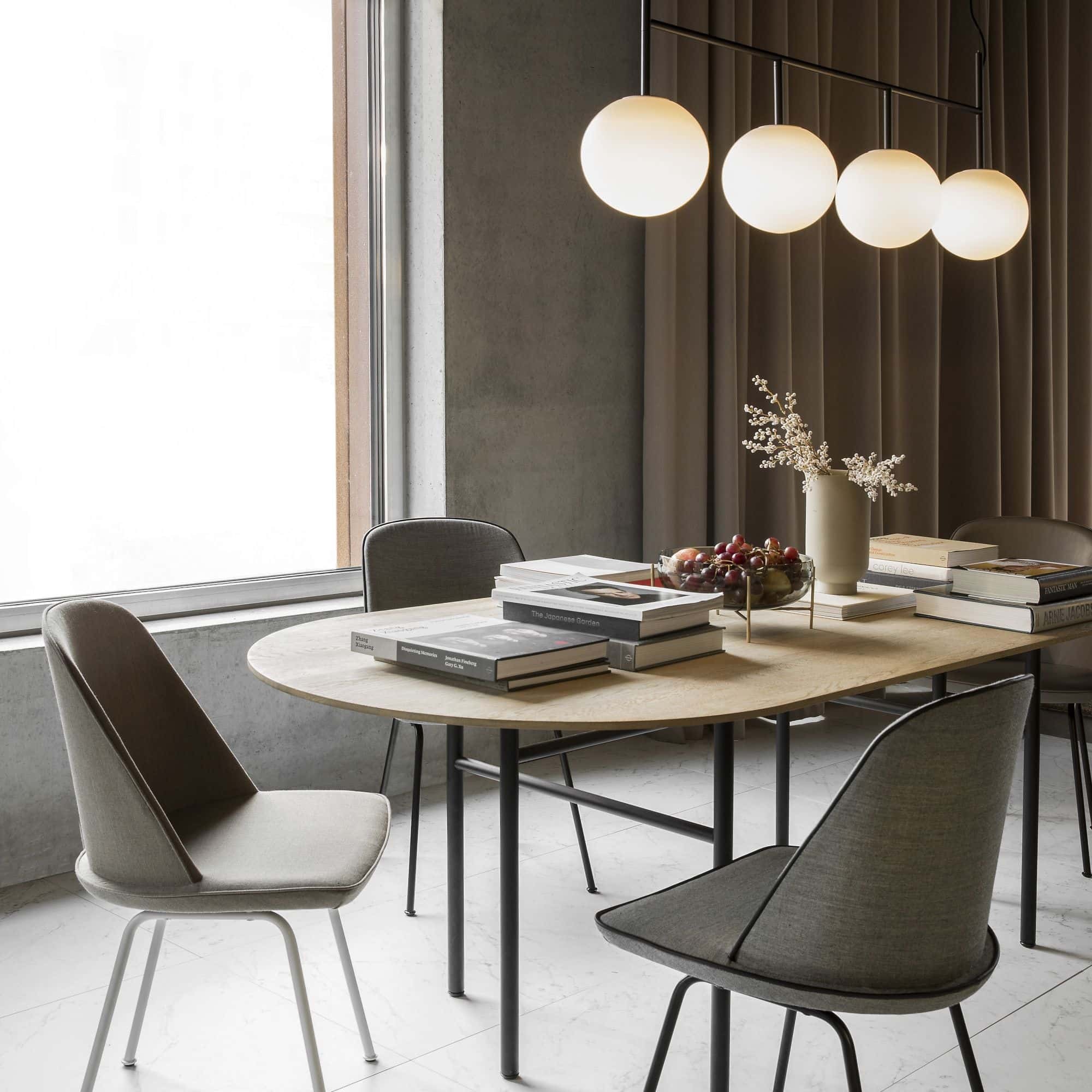 four bulb pendant light over brown oval dining table