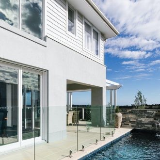 grey and white hamptons home facade and indoor swimming pool metricon