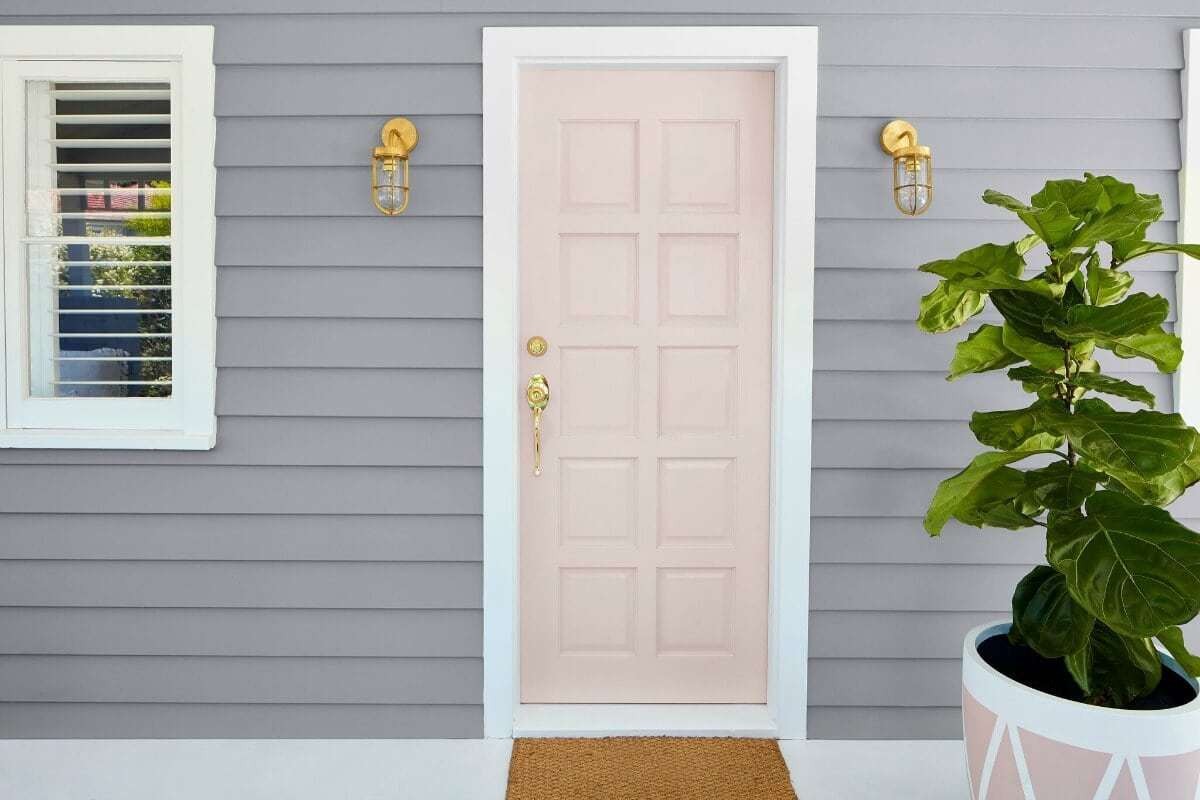 grey home with light pink front door and gold handle from taubmans paint