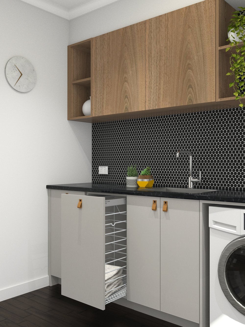 grey laundry room with black tiles and tan leather cabinetry handles