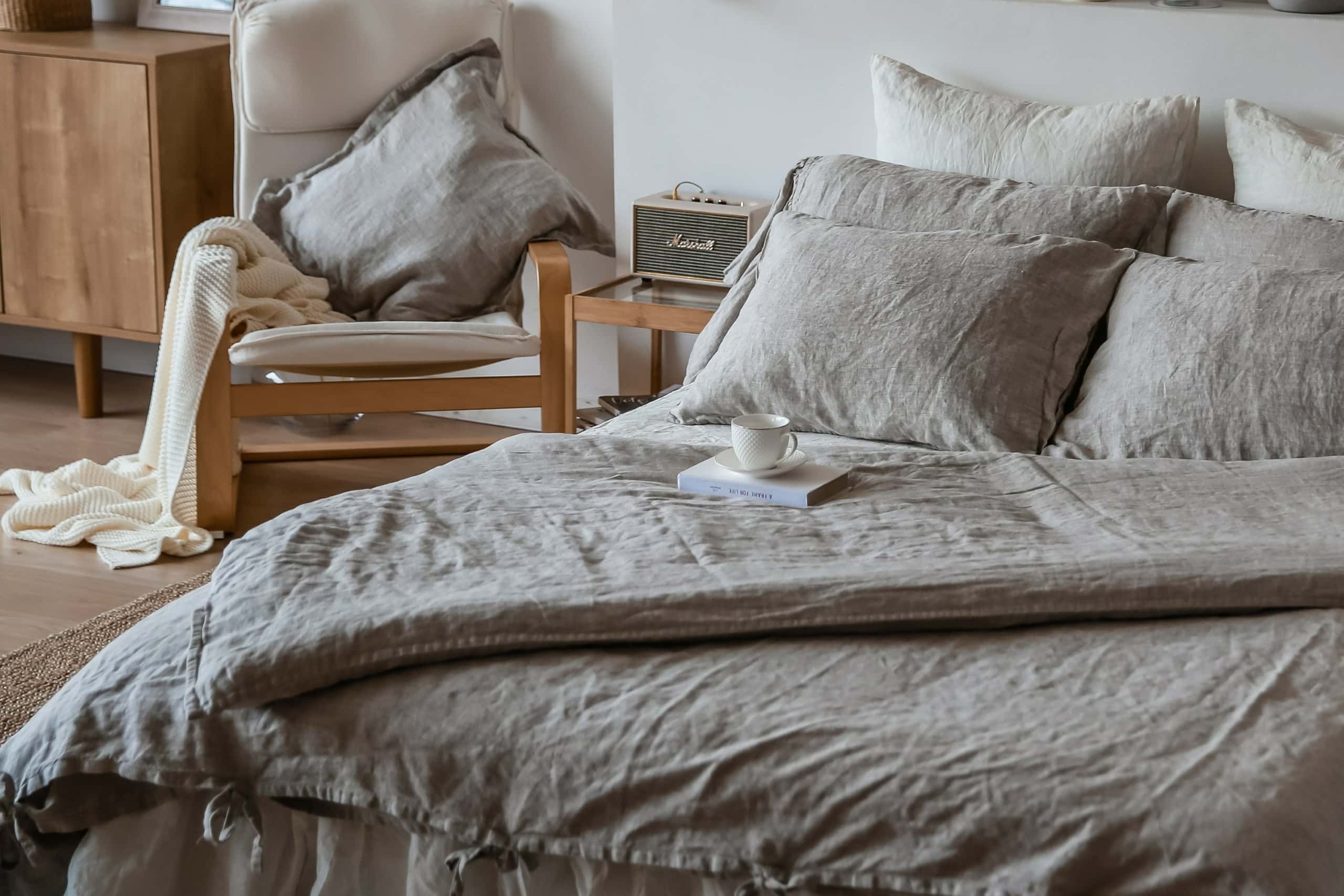 grey organic bed linen in rustic bedroom