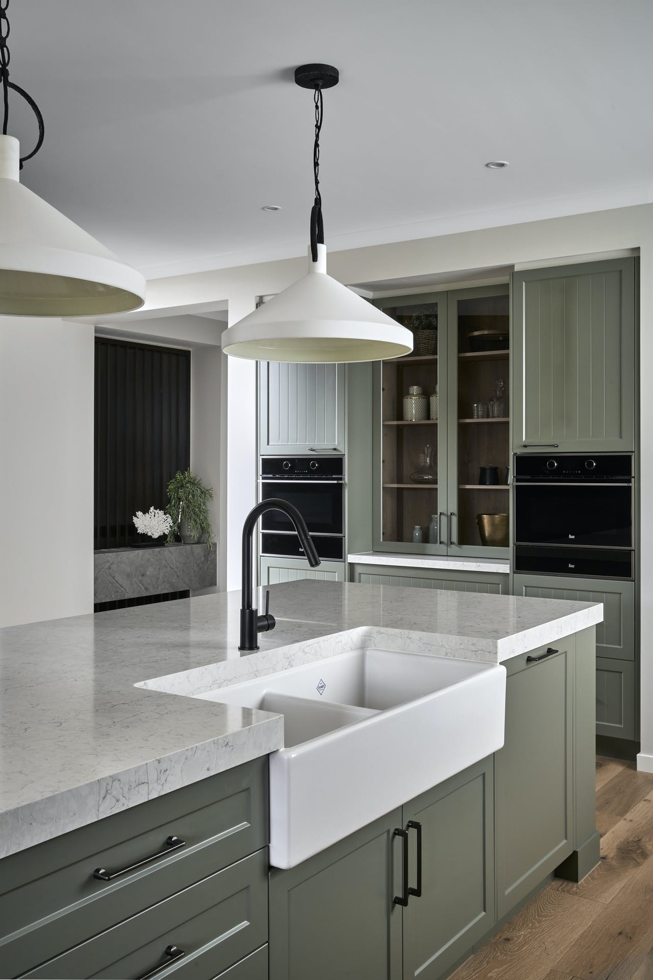 gumnut green kitchen cabinets in country kitchen with black tapware metricon sovereign