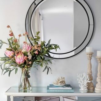 hamptons-mirror-console-table-in-entryway-with-round-black-mirror-and-coastal-styling
