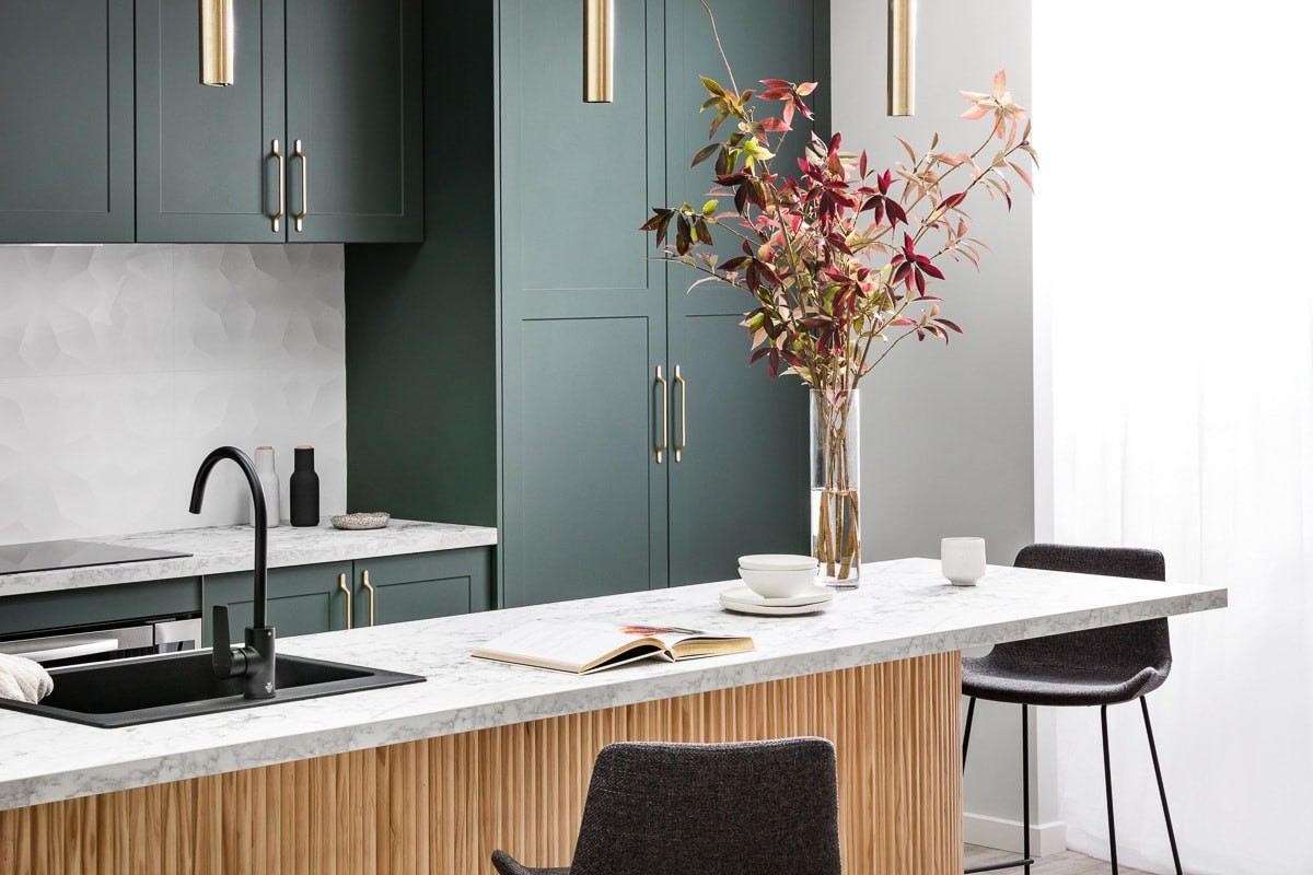 kaboodle kitchen dark green kitchen cabinets with gold brass handles and white marble countertop