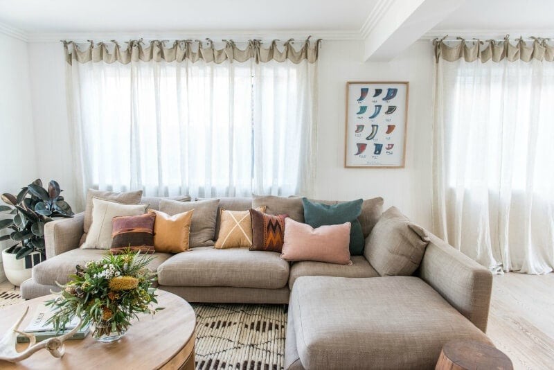 kyal and kara renovation living room with sheer curtains and beige sofa