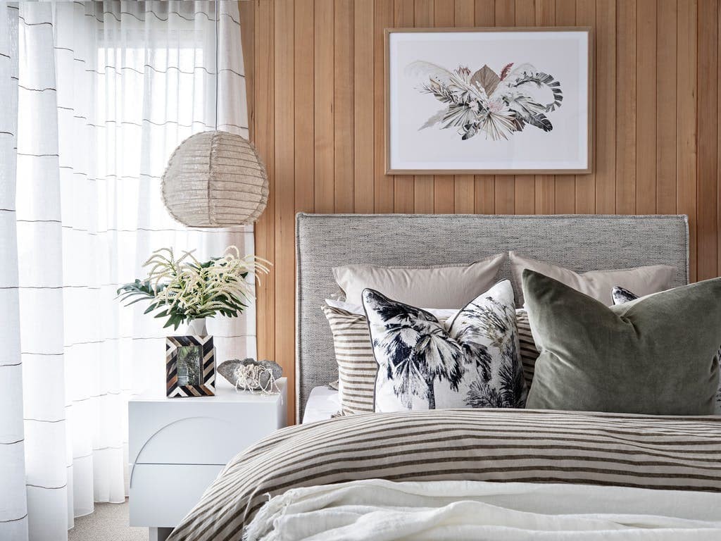 light timber vj paneling in bedroom with sheer curtains and grey bed