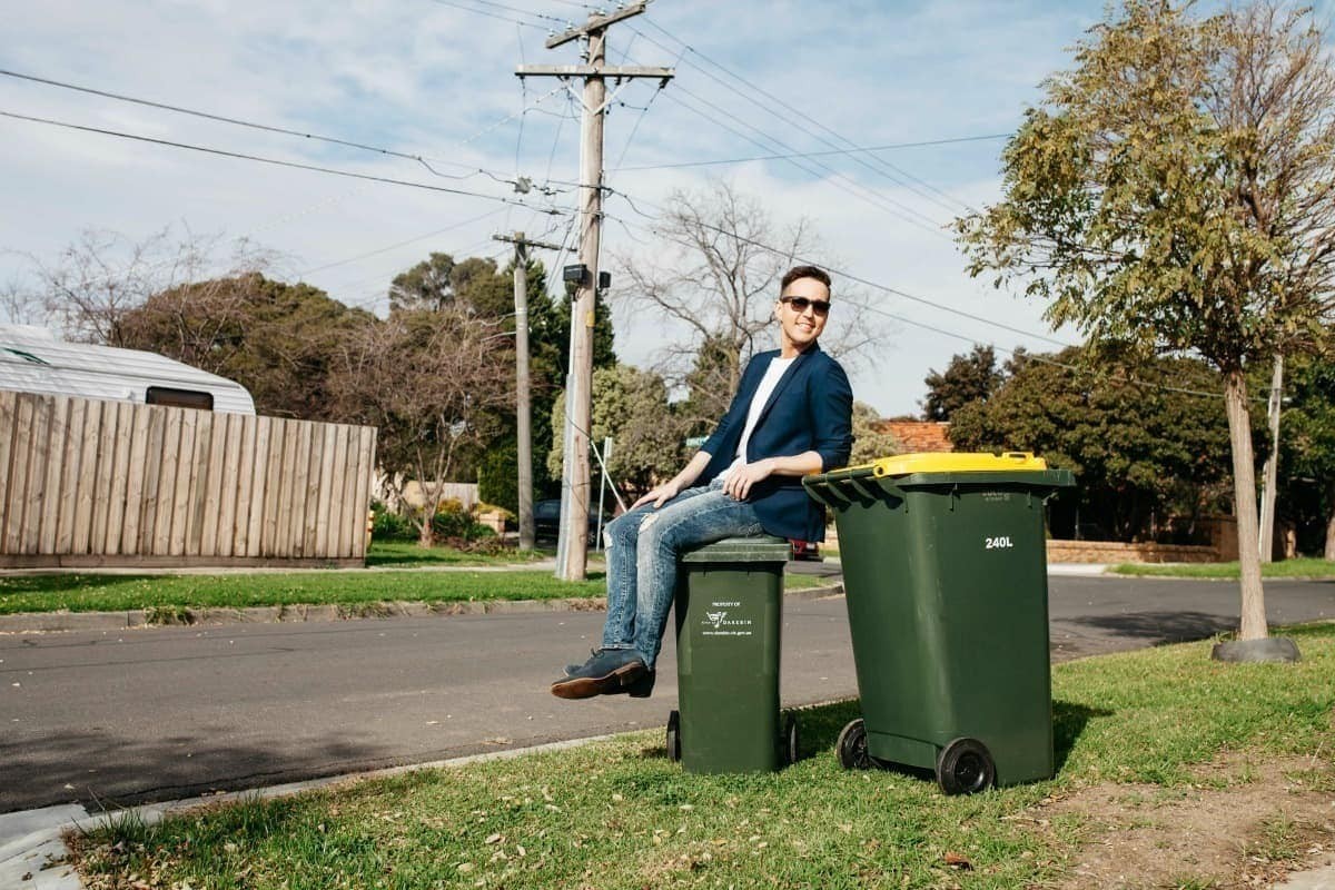 living in the suburbs sitting on top of garbage bin
