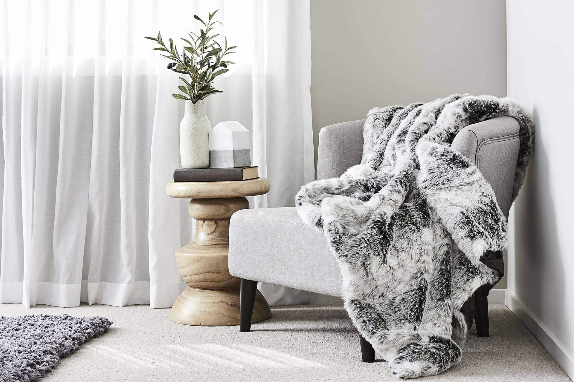 melbourne interior designers tlc interiors grey armchair with faux fur throw