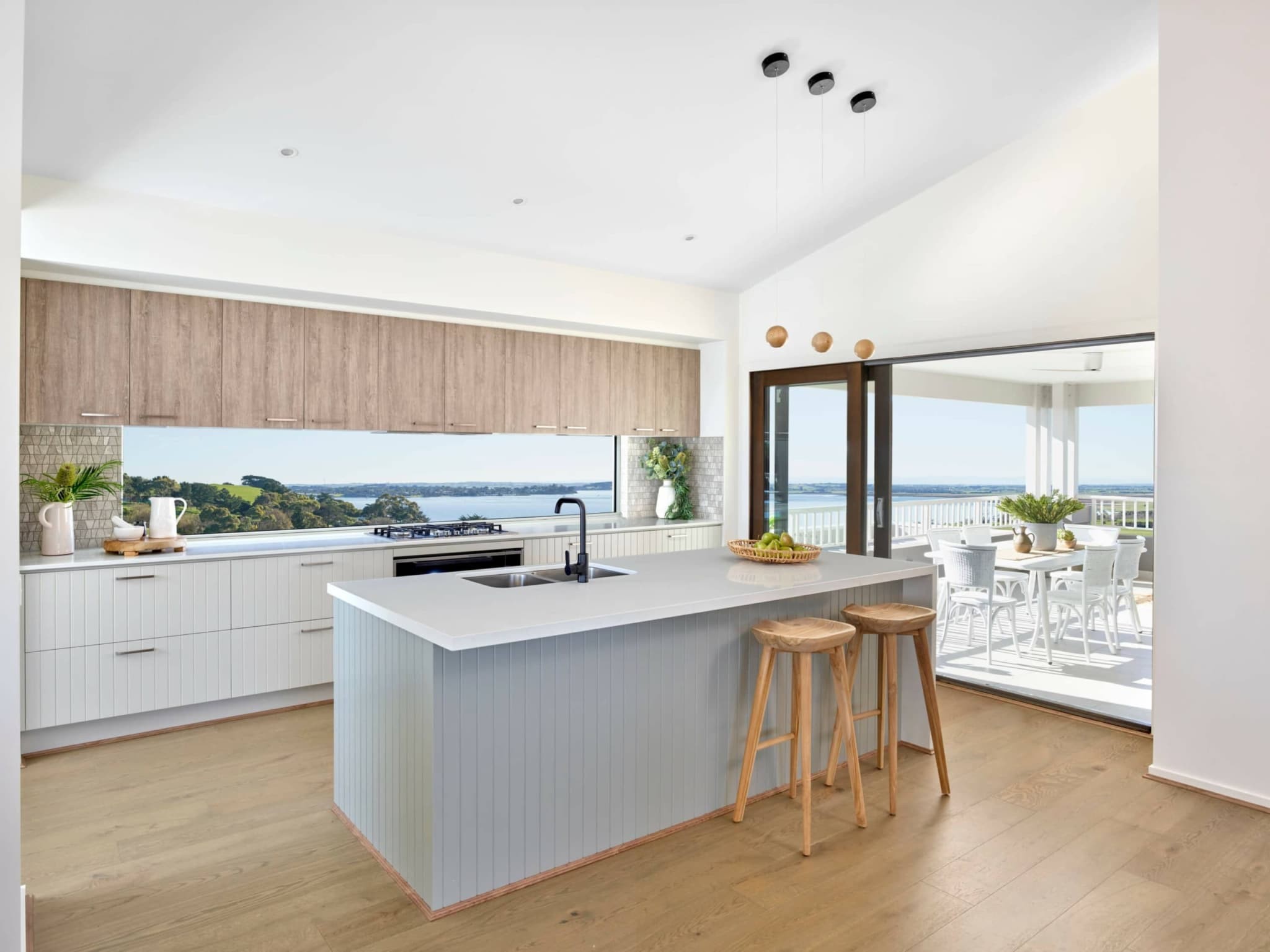 metricon coastal kitchen with vj panel cabinets and glass window splashback