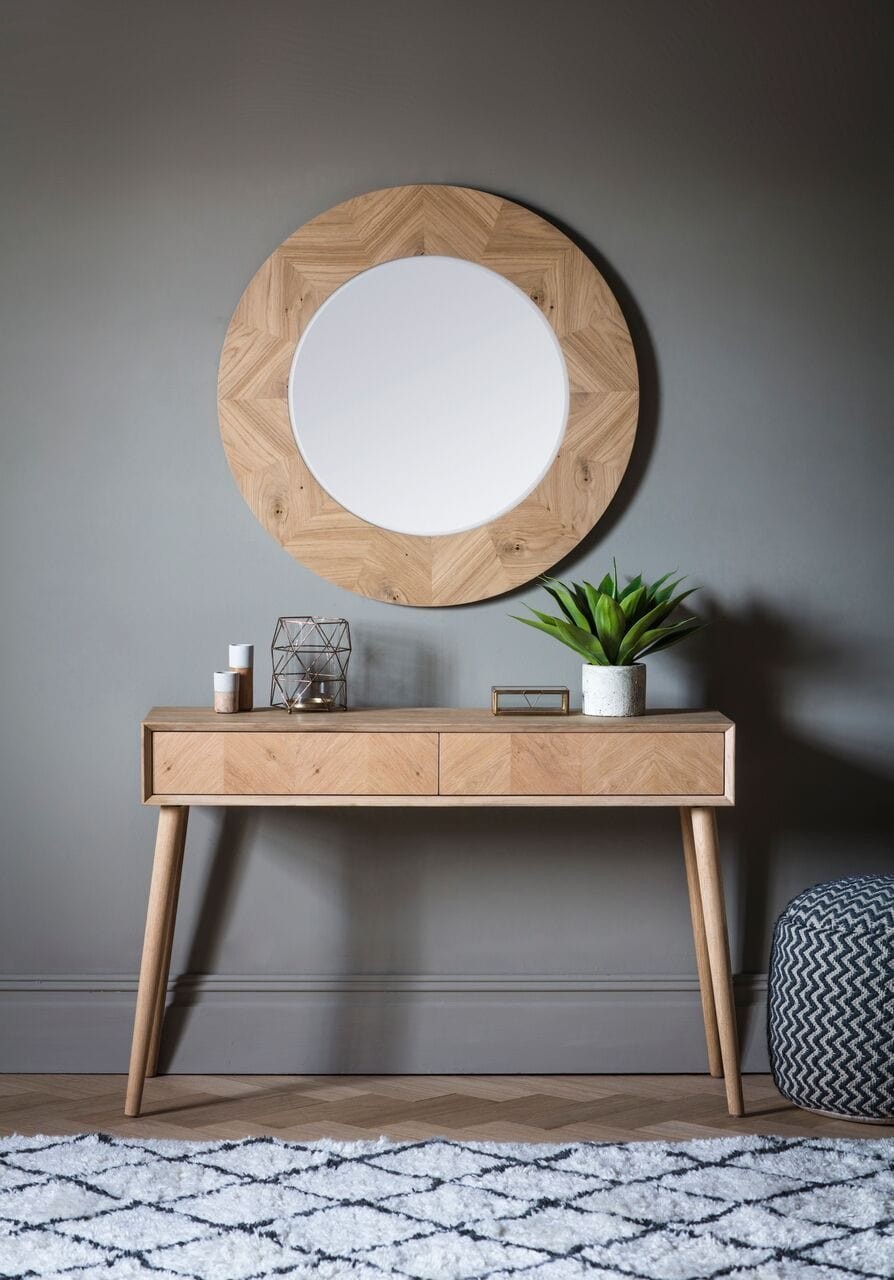 millard large round timber mirror against charcoal grey wall