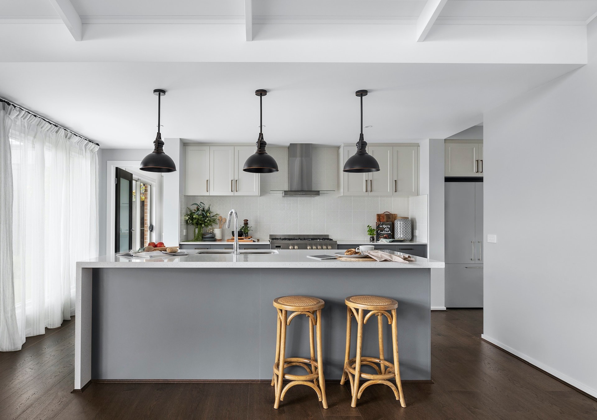 modern country kitchen with black industrial pendant lights over kitchen island