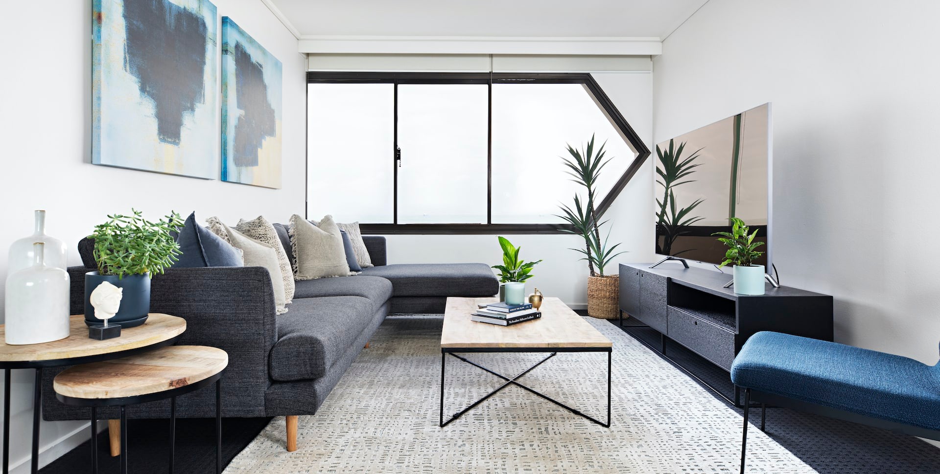 moody coastal interior design living room with grey sofa blue armchair st kilda apartment