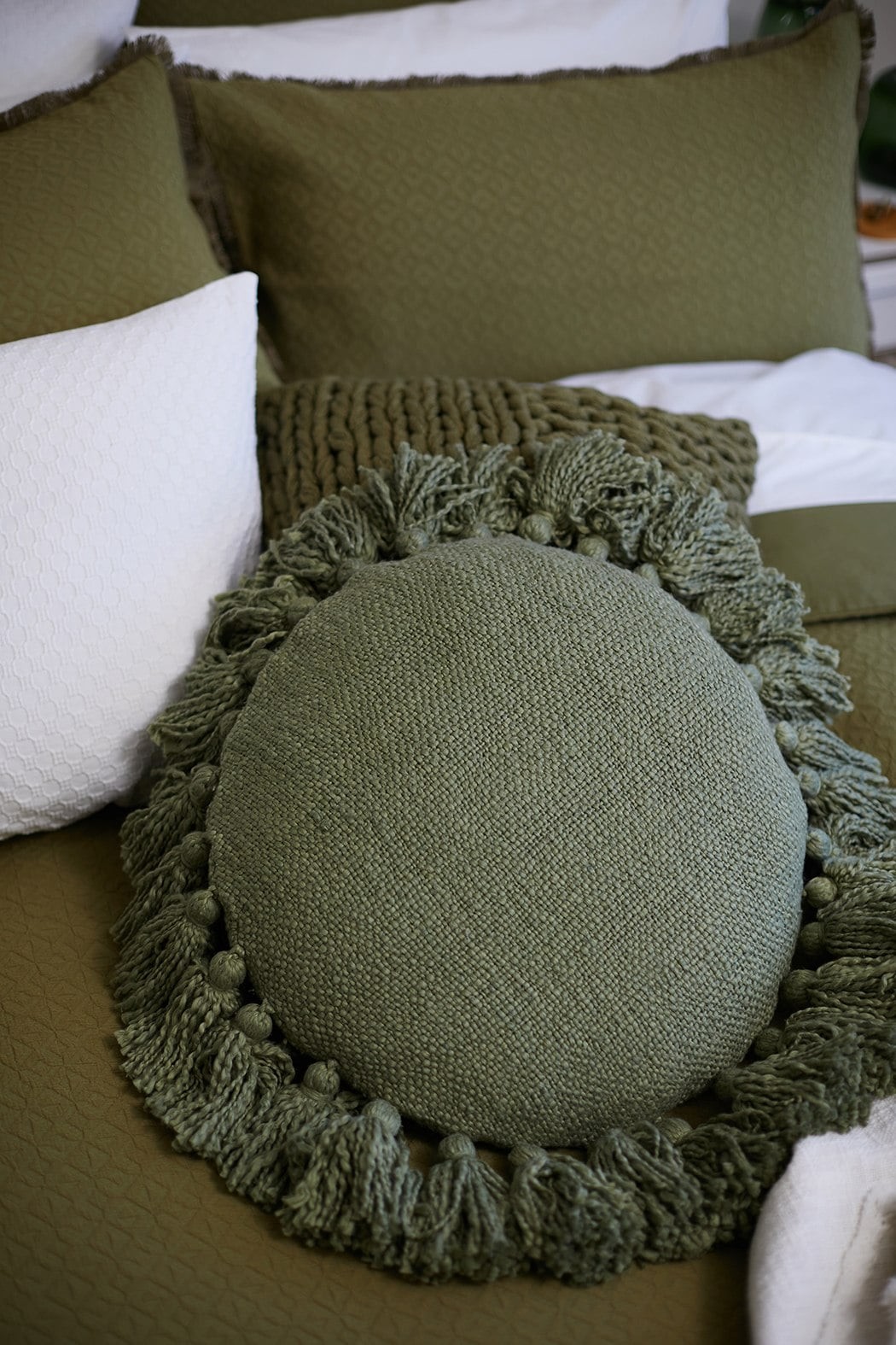 olive green round cushion with tassels lorrain lea bedding