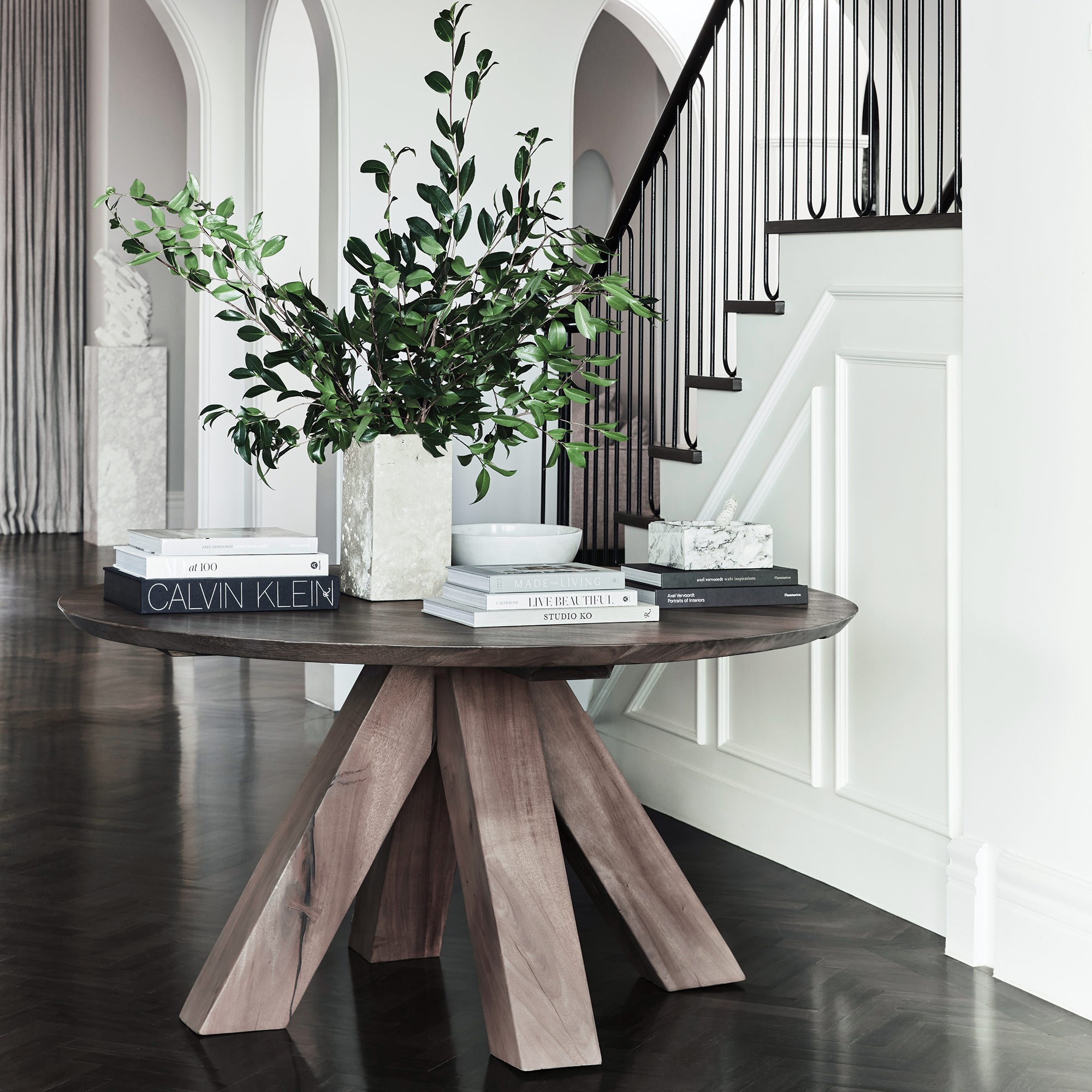 organic luxe round timber table in home entry foyer coco republic