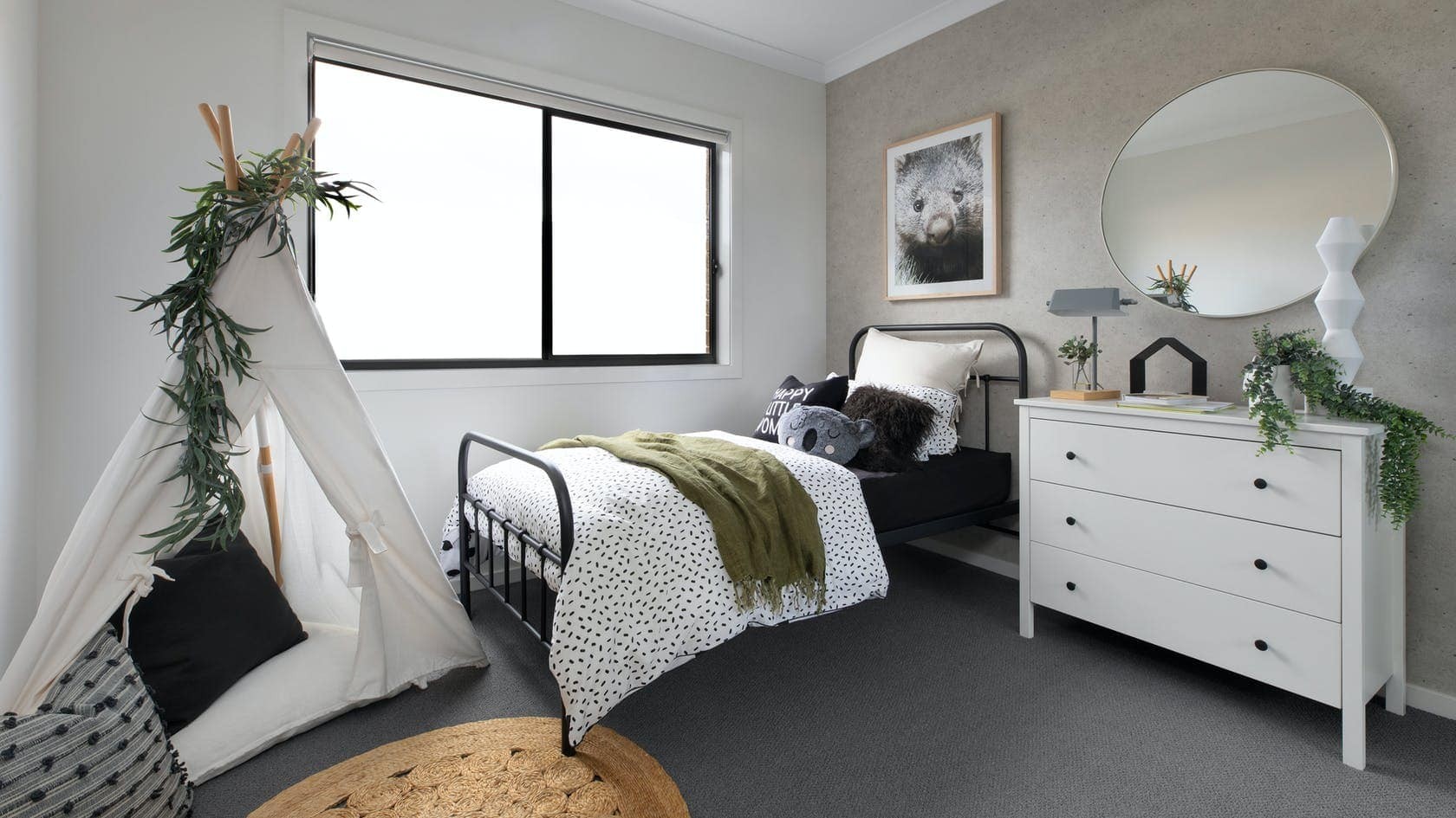 single black metal bed frame styled in kids bedroom with koala cushion