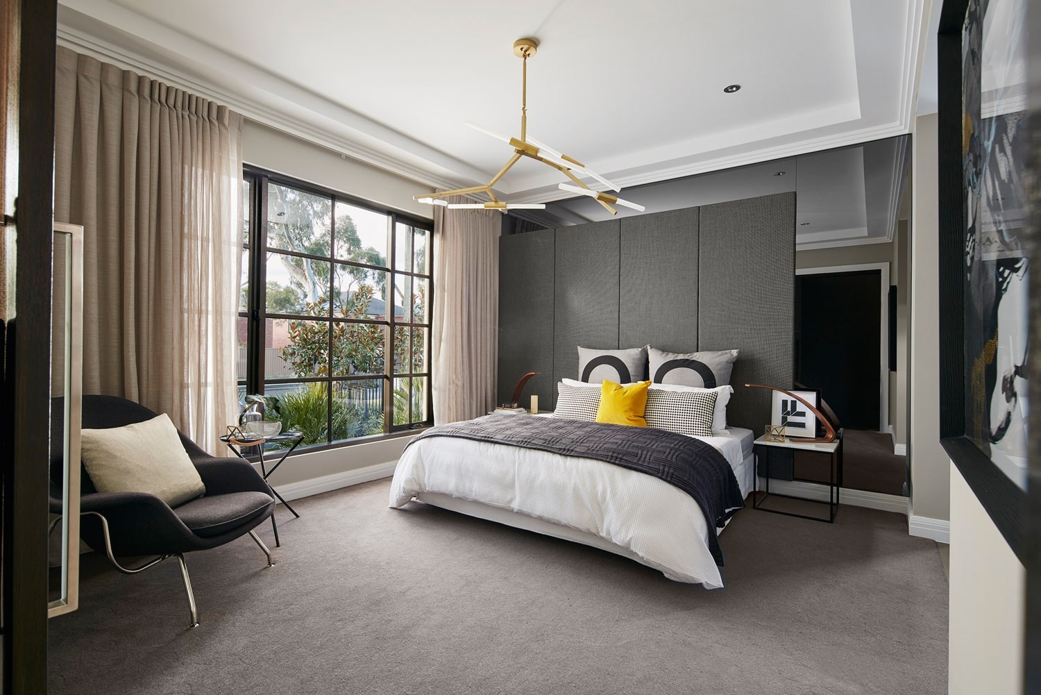 sophisticated master bedroom feature wall panels and tinted mirror behind bedhead