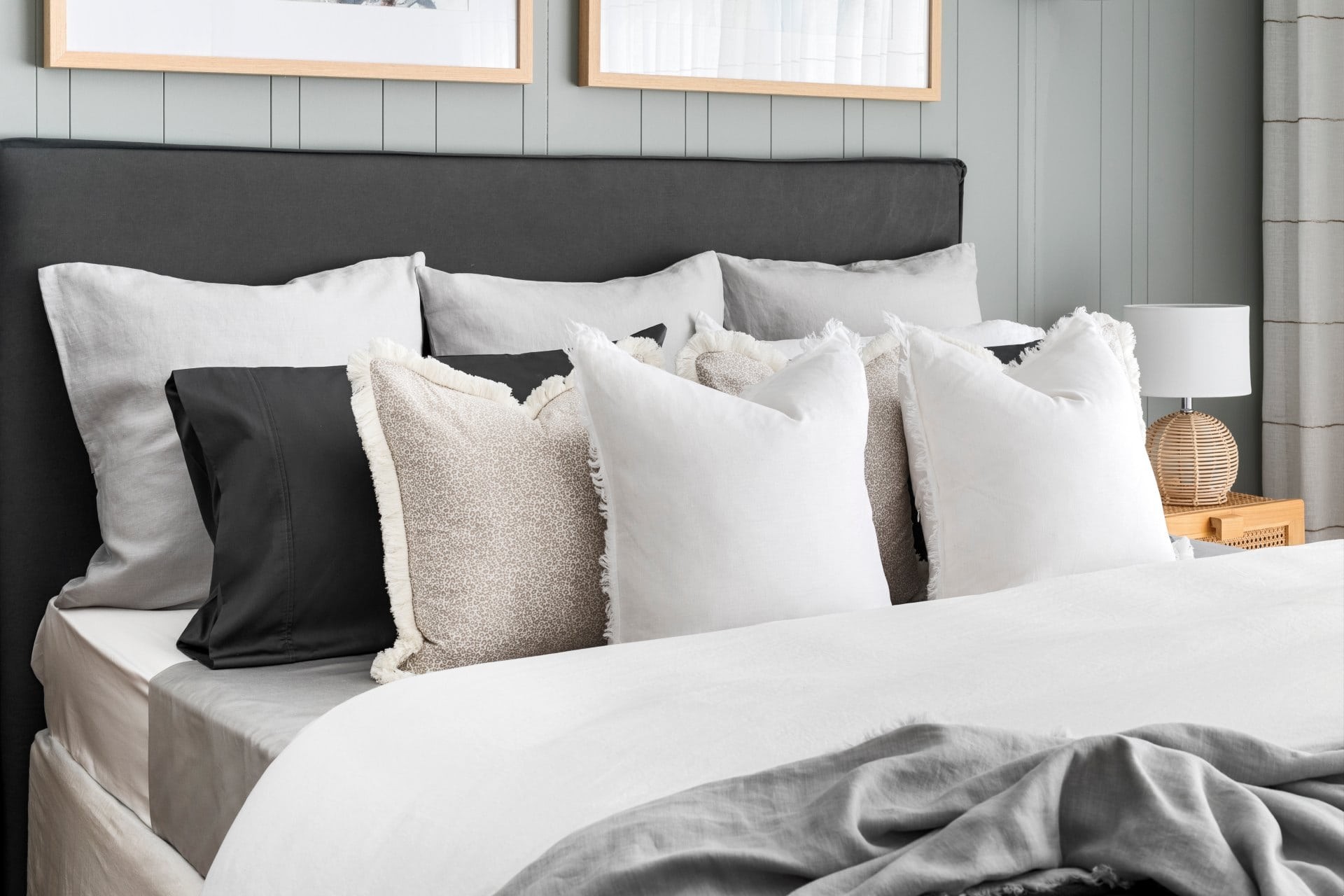 styling a bed with pillows and cushions white bedding grey headboard sage green vj panel wall