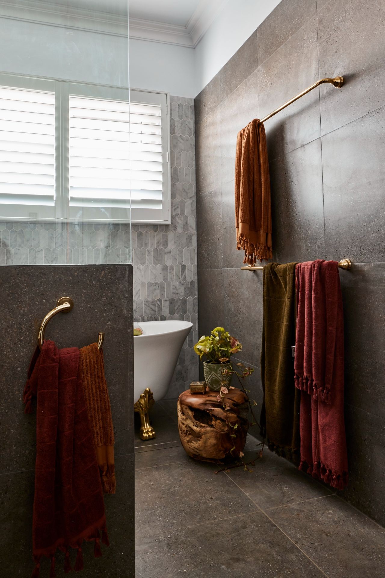 the block 2020 bathroom reveal ankur and sharon dark moody bathroom with grey floor tiles brass hardware