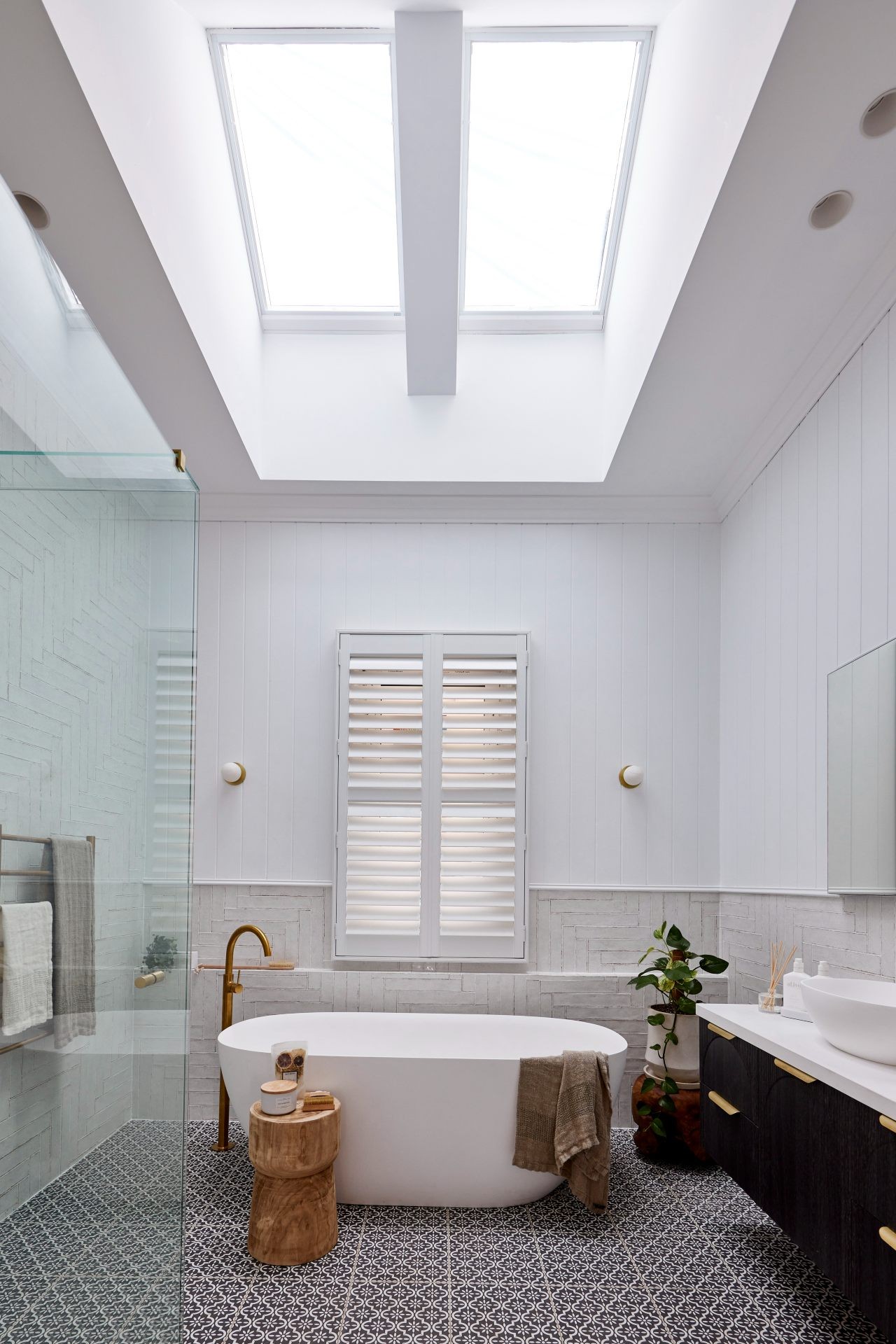 the block 2020 bathroom reveal omar and oz bathroom with white plantation shutters and skylight