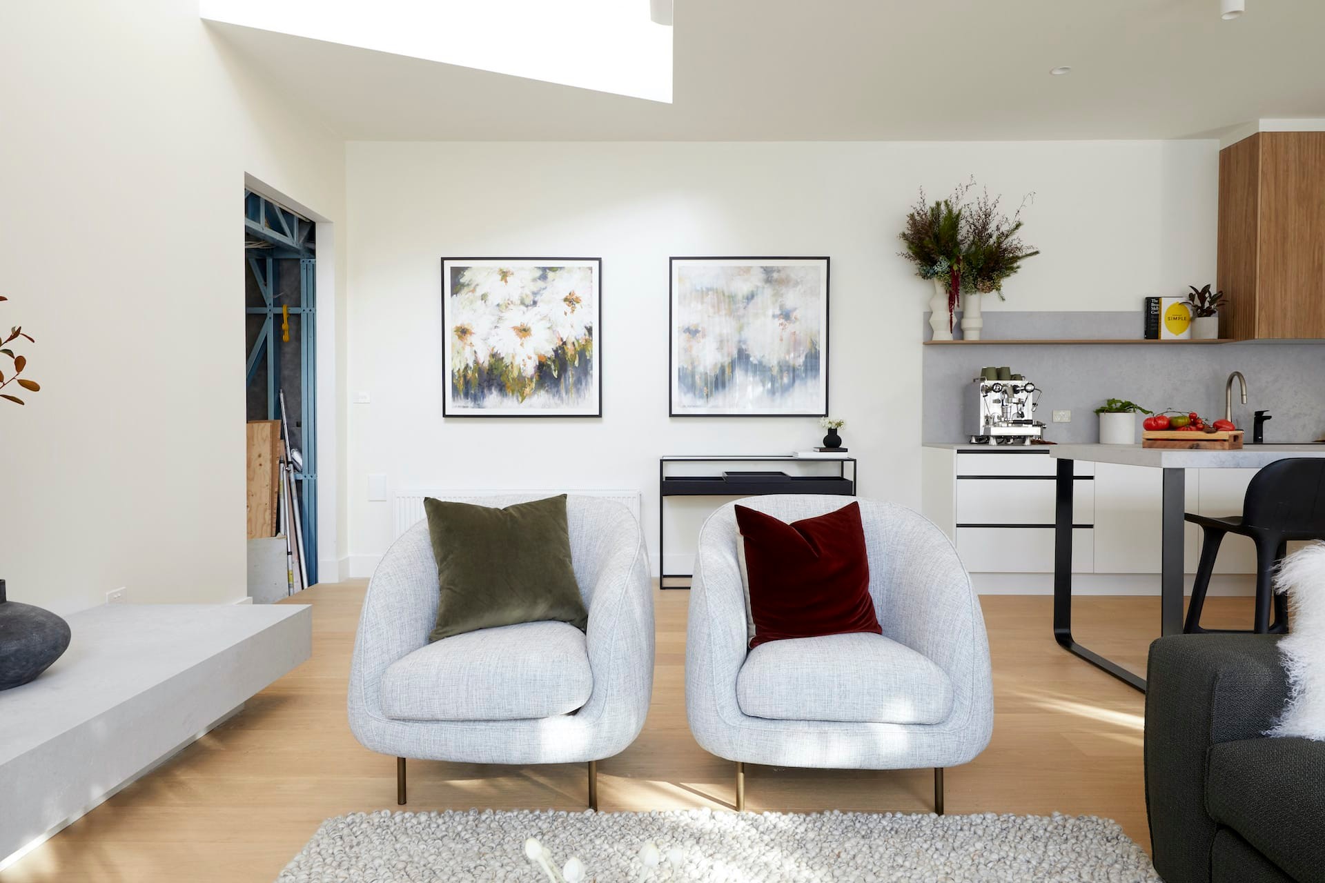 the block 2020 harry and tash living room with grey armchairs and jewel tone cushions