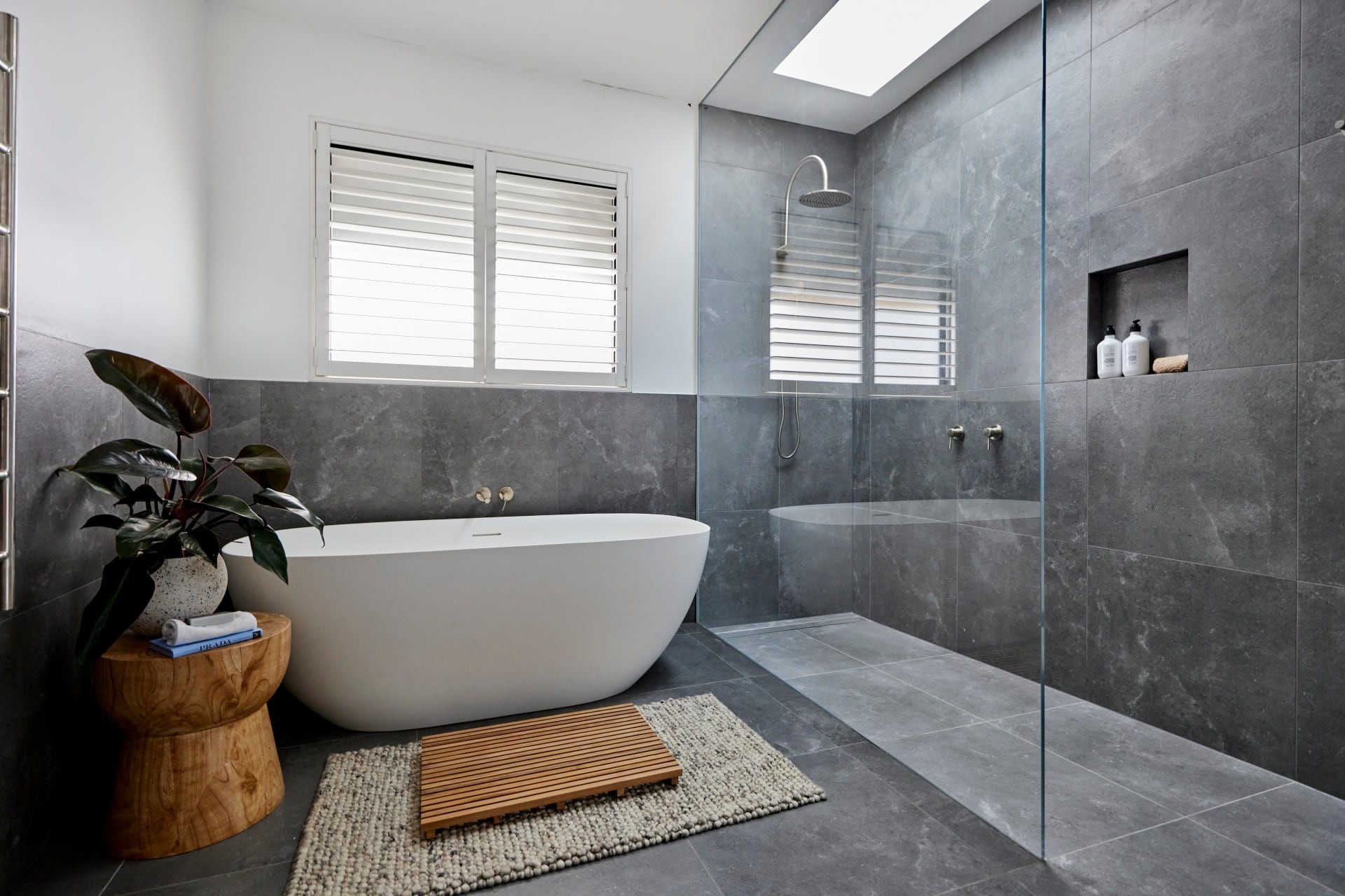 the block 2021 josh and luke bathroom with dark grey wall and floor tiles