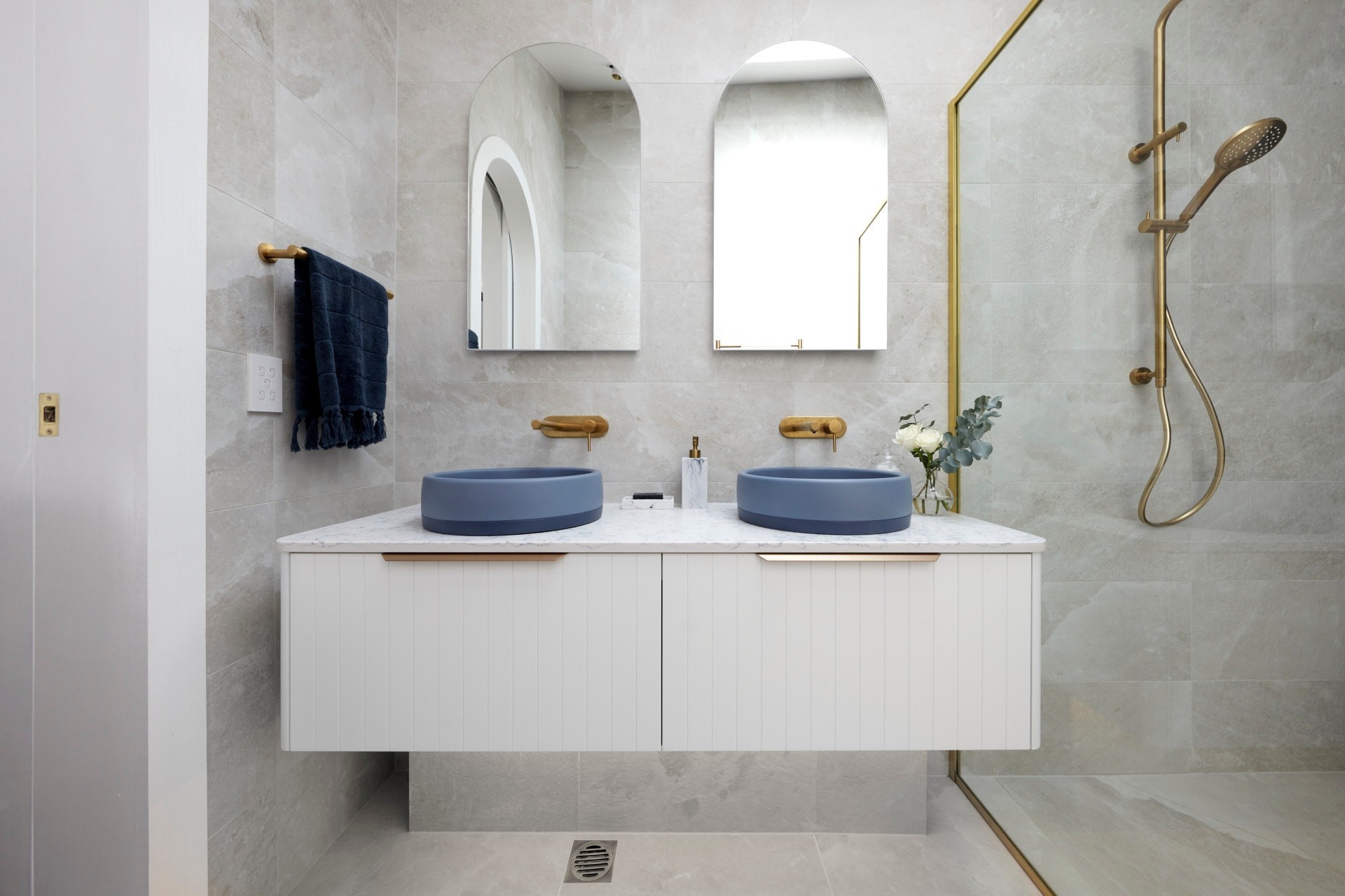 the block 2021 kirsty and jesse master ensuite white floating vanity with blue round basins and brass taps