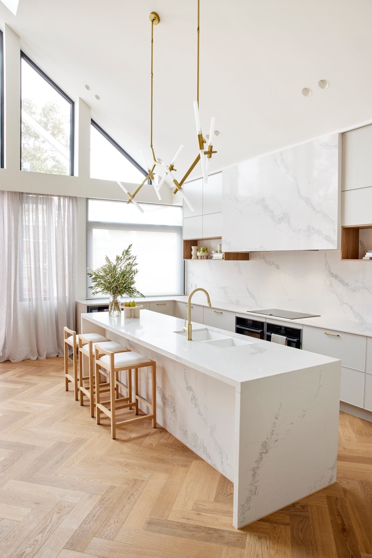 the block 2021 ronnie and georgia kitchen with brass pendant lights above marble kitchen island
