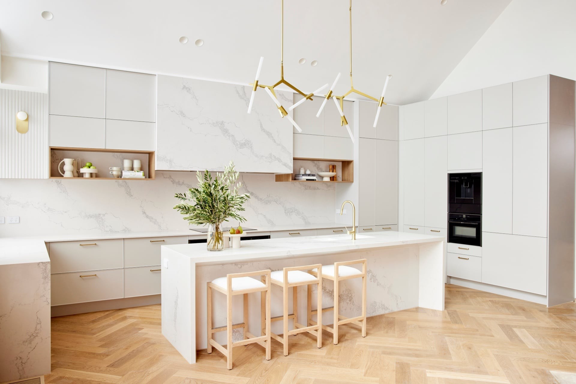 the block 2021 ronnie and georgia kitchen with marble counterops light grey cabinets brass pendant lights