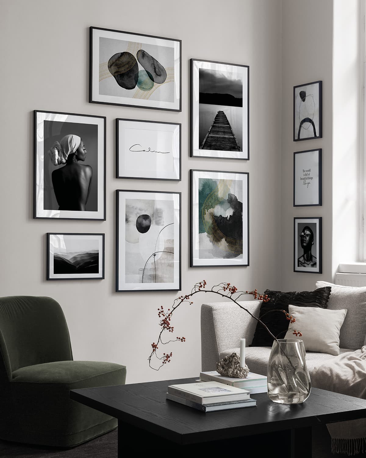 think black frame gallery wall with black and white desenio artworks wrapping around corner