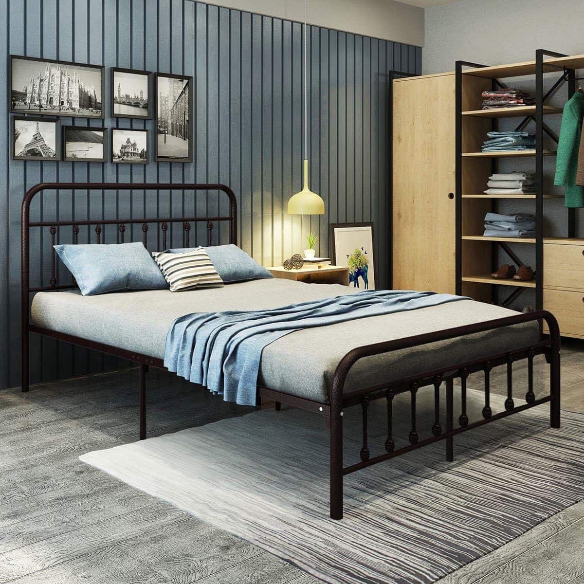 vintage black metal bed frame in teenage boys room with blue wallpaper and striped rug