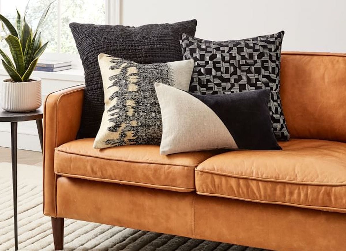 west elm australia pattern cushions on tan leather sofa