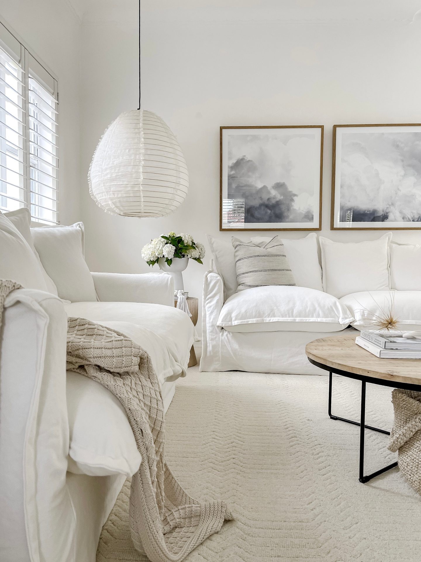 white coastal living room with white slipcover sofa textured beige floor rug miss amara