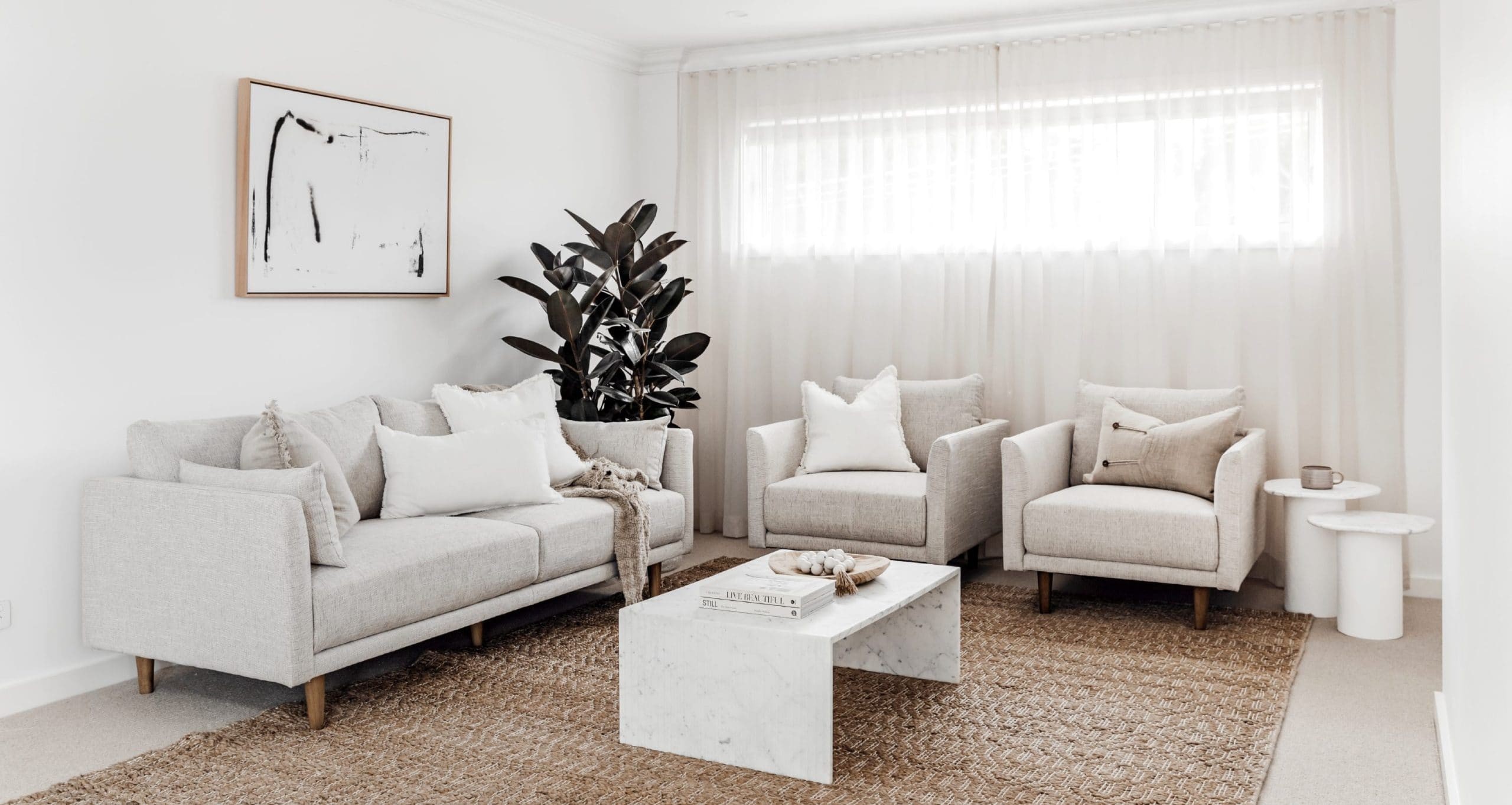 white living room with grey sofa jute rug white sheer curtains miss amara